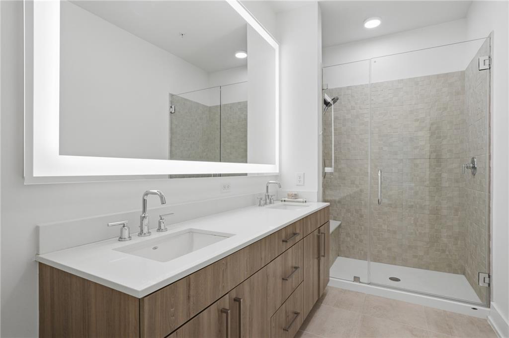 775 Juniper Street Northeast, Unit 322 Atlanta, GA 30308 - Photo 13 of 34 a bathroom with a sink a toilet and a mirror