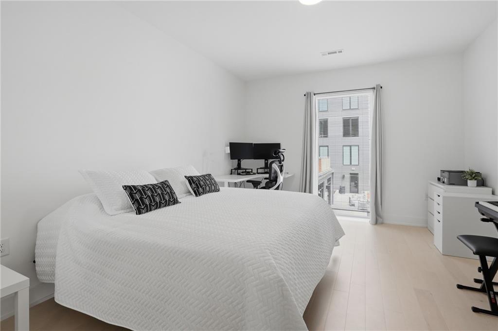 775 Juniper Street Northeast, Unit 322 Atlanta, GA 30308 - Photo 14 of 34 a bedroom with a bed and furniture