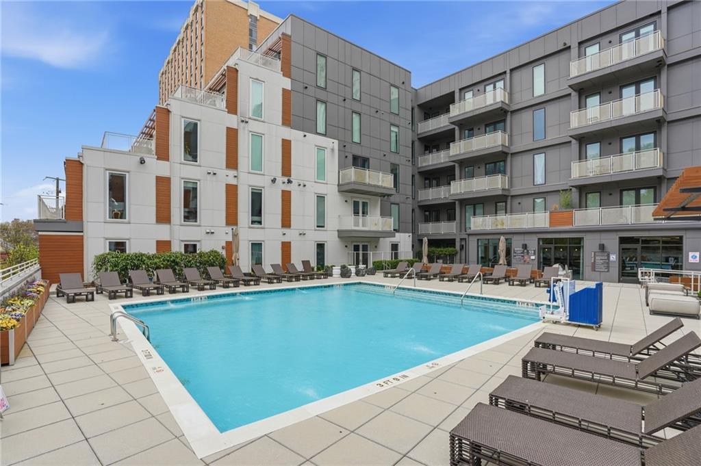 775 Juniper Street Northeast, Unit 322 Atlanta, GA 30308 - Photo 24 of 34 a front view of a building with swimming pool and seating space