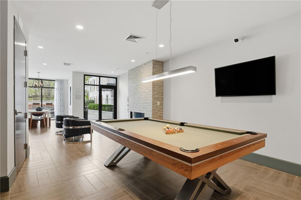 775 Juniper Street Northeast, Unit 322 Atlanta, GA 30308 - Photo 26 of 34 a living room with pool table flat screen tv and windows