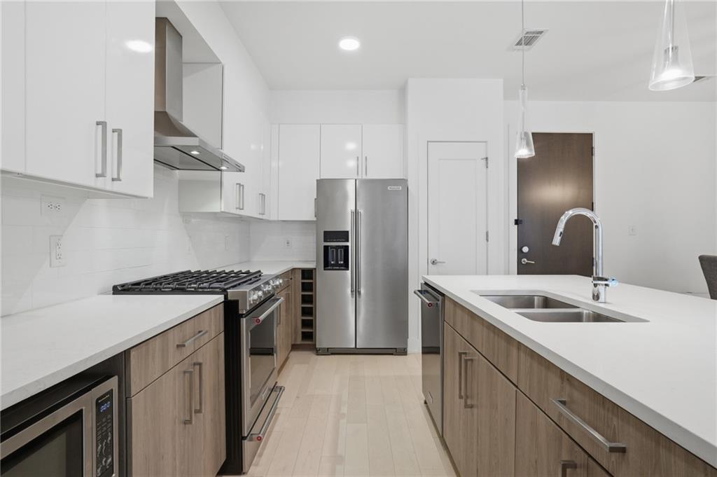 775 Juniper Street Northeast, Unit 322 Atlanta, GA 30308 - Photo 7 of 34 a kitchen with a sink stove and refrigerator
