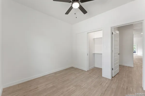 a view of empty room with wooden floor