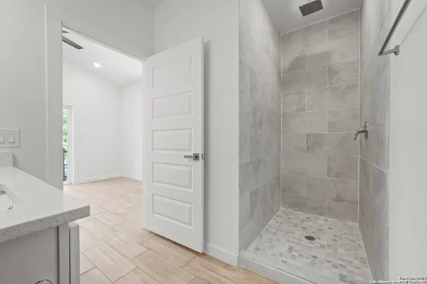 a bathroom with a shower and a sink