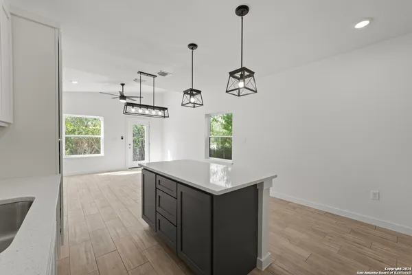 a kitchen with a counter space and wooden floor