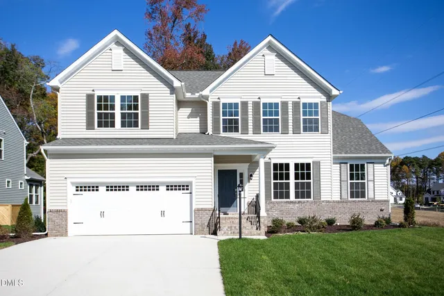 a view of house with yard