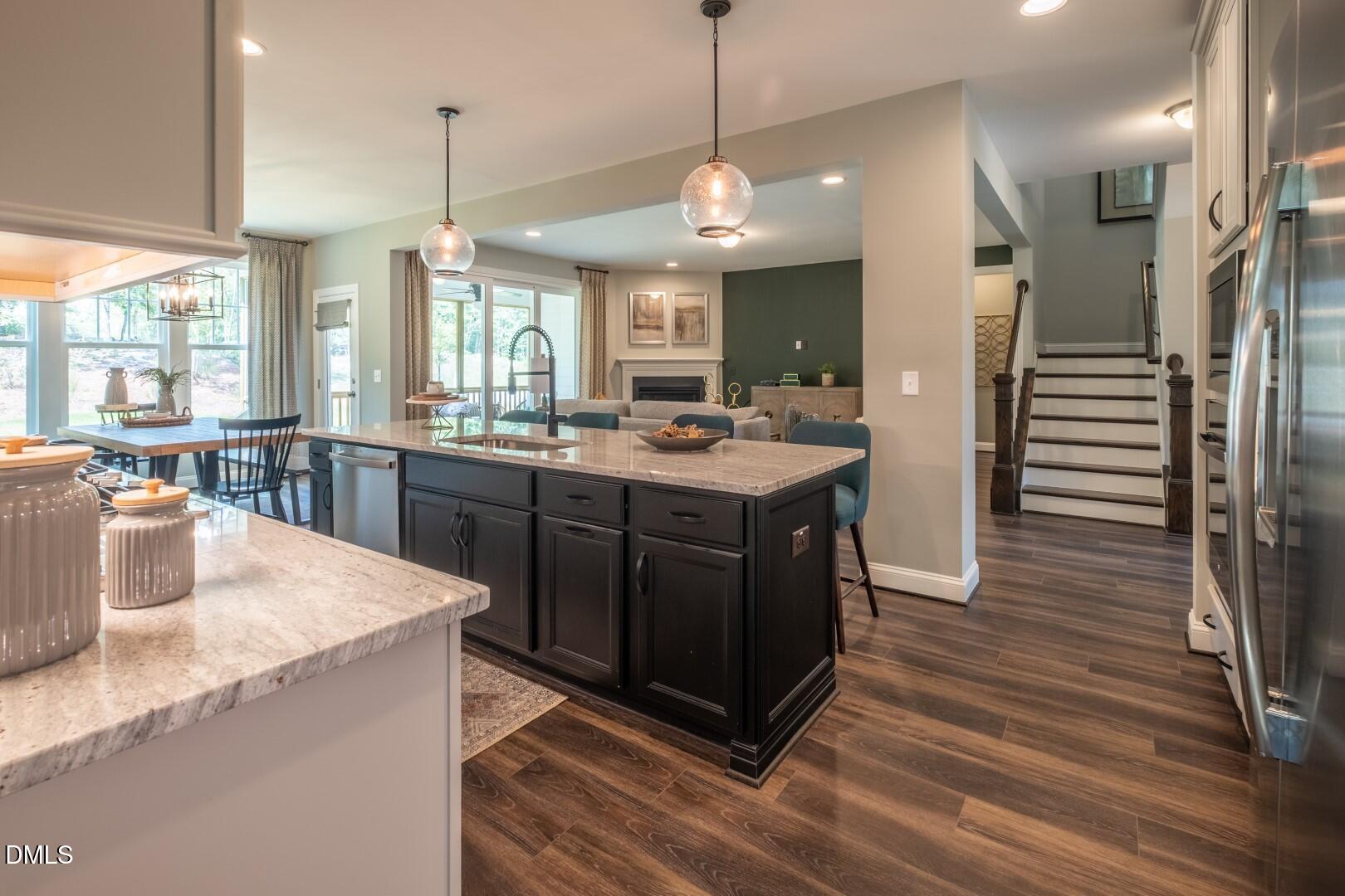 326 Oak Meadow Lane Angier, NC 27501 - Photo 16 of 41 a kitchen with stainless steel appliances granite countertop a sink a stove and a wooden floor