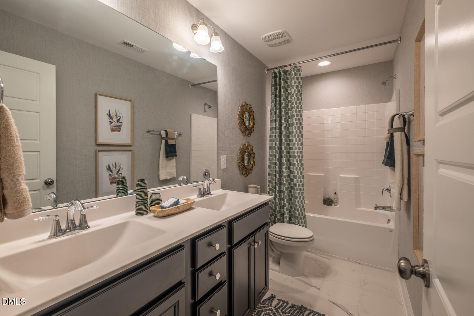 326 Oak Meadow Lane Angier, NC 27501 - Photo 35 of 41 a bathroom with a double vanity sink toilet mirror and shower