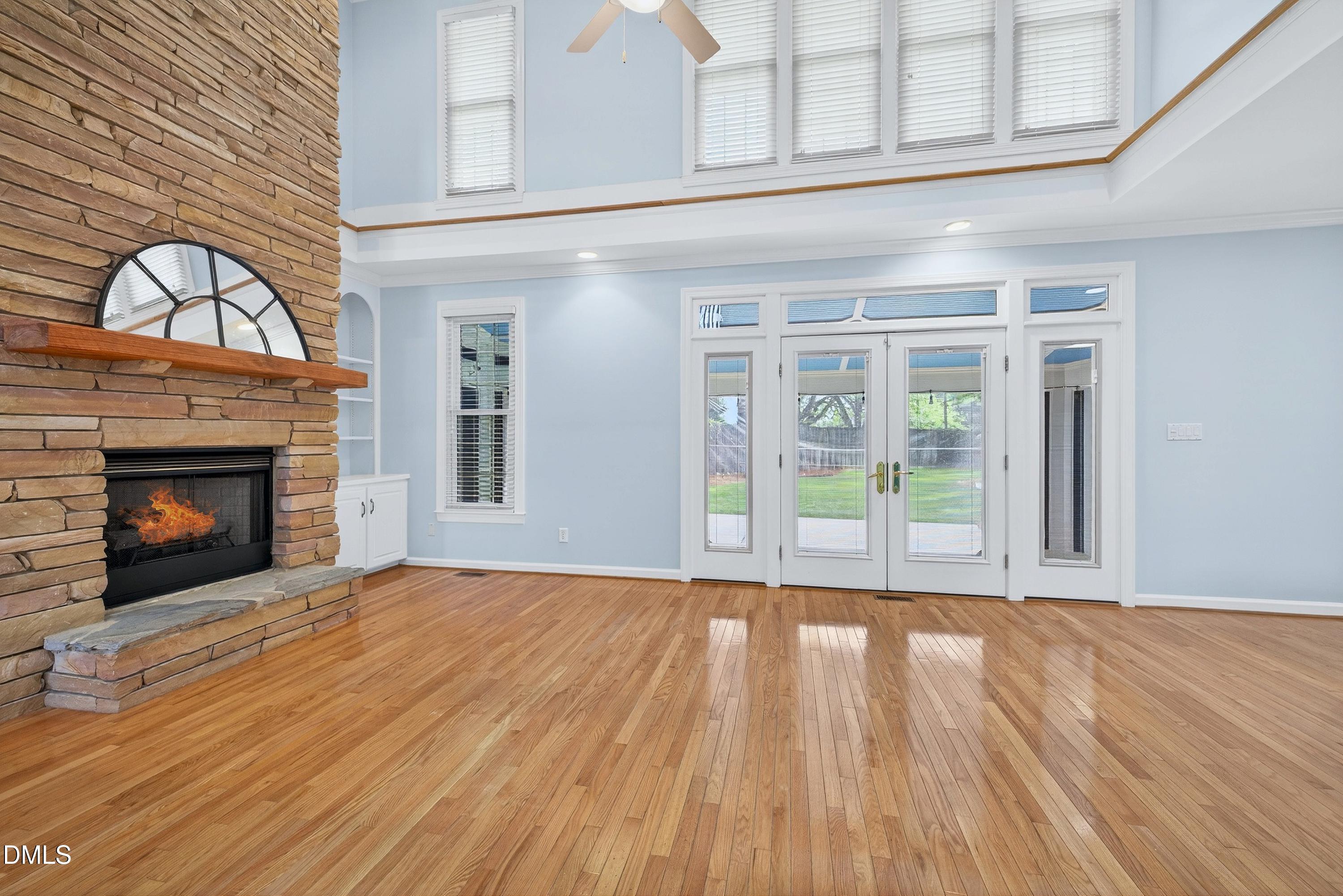 2217 Moss Point Lane Raleigh, NC 27606 - Photo 12 of 70 a view of an empty room with wooden floor fireplace and a window