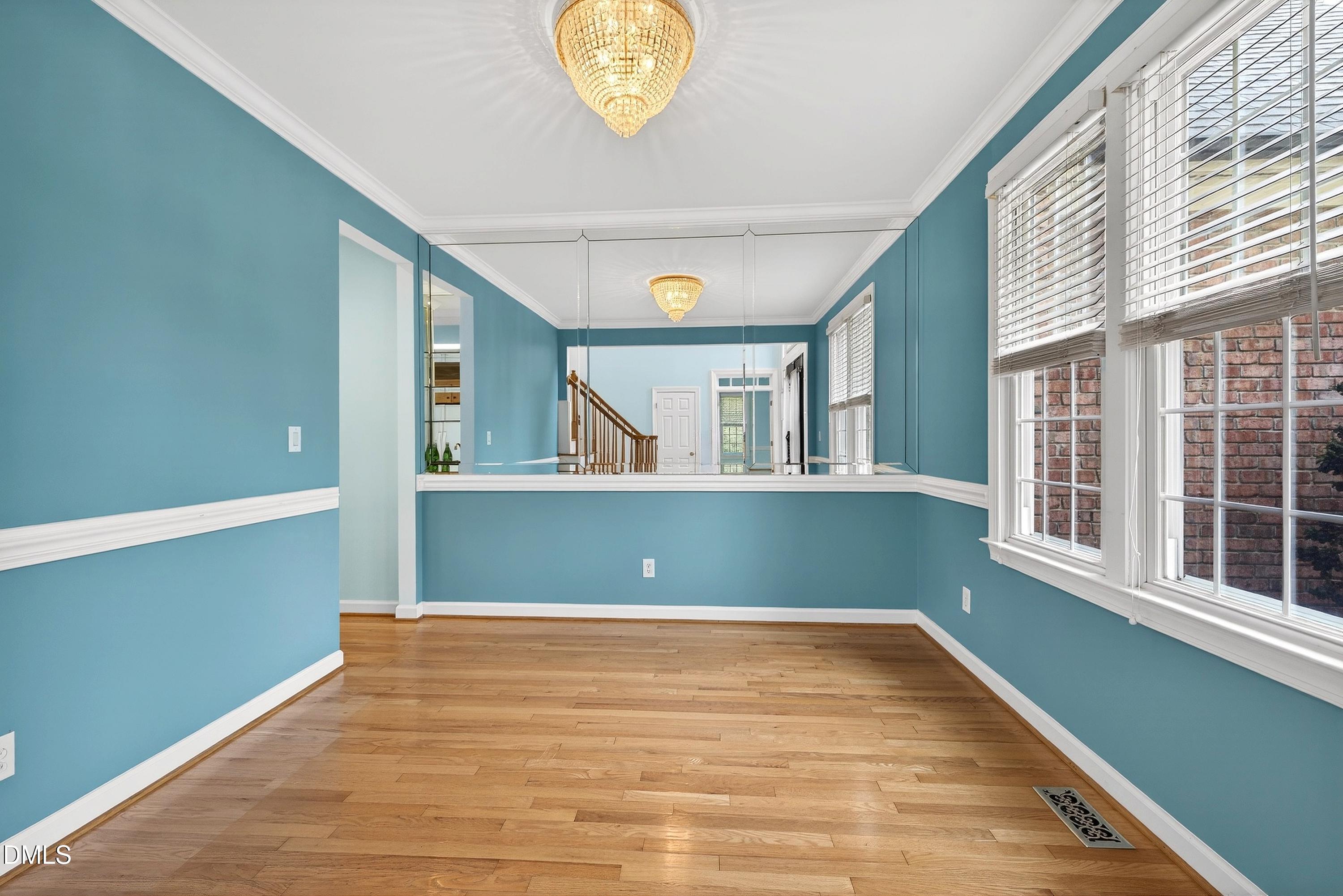 2217 Moss Point Lane Raleigh, NC 27606 - Photo 14 of 70 a view of a big room with wooden floor and windows