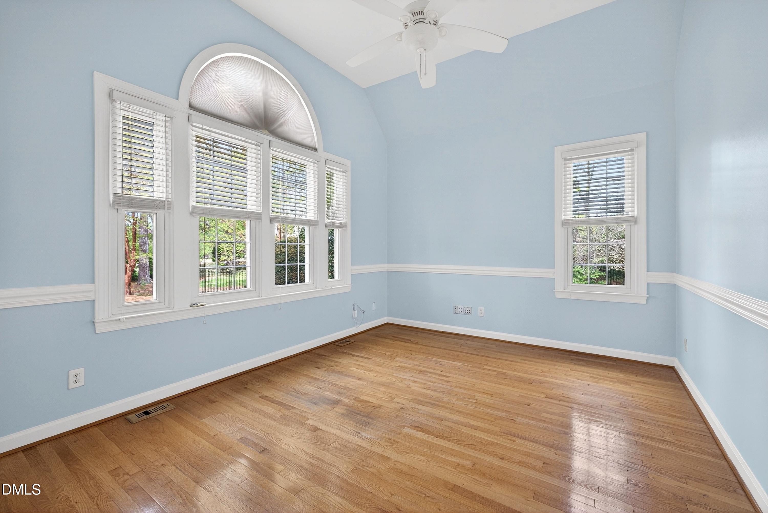 2217 Moss Point Lane Raleigh, NC 27606 - Photo 16 of 70 an empty room with wooden floor and windows