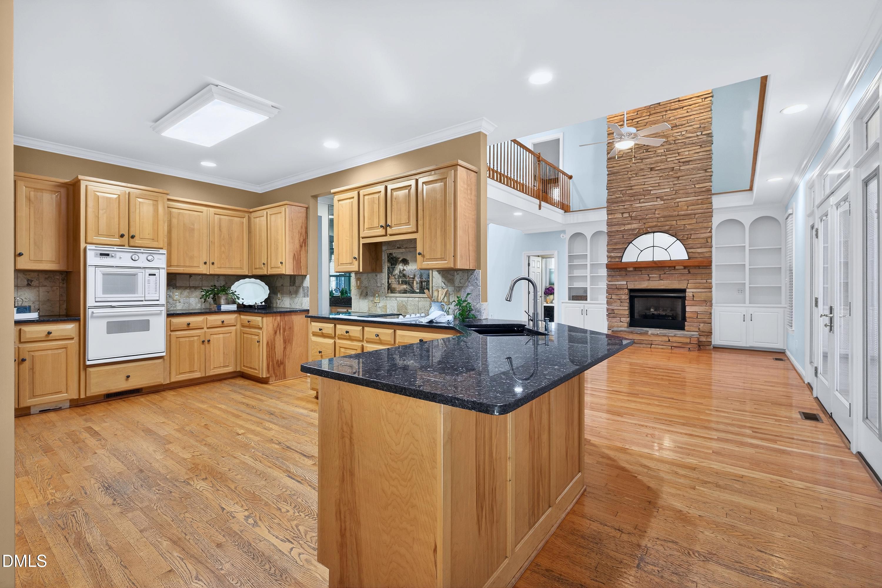 2217 Moss Point Lane Raleigh, NC 27606 - Photo 17 of 70 a large kitchen with stainless steel appliances granite countertop a stove a sink and a refrigerator