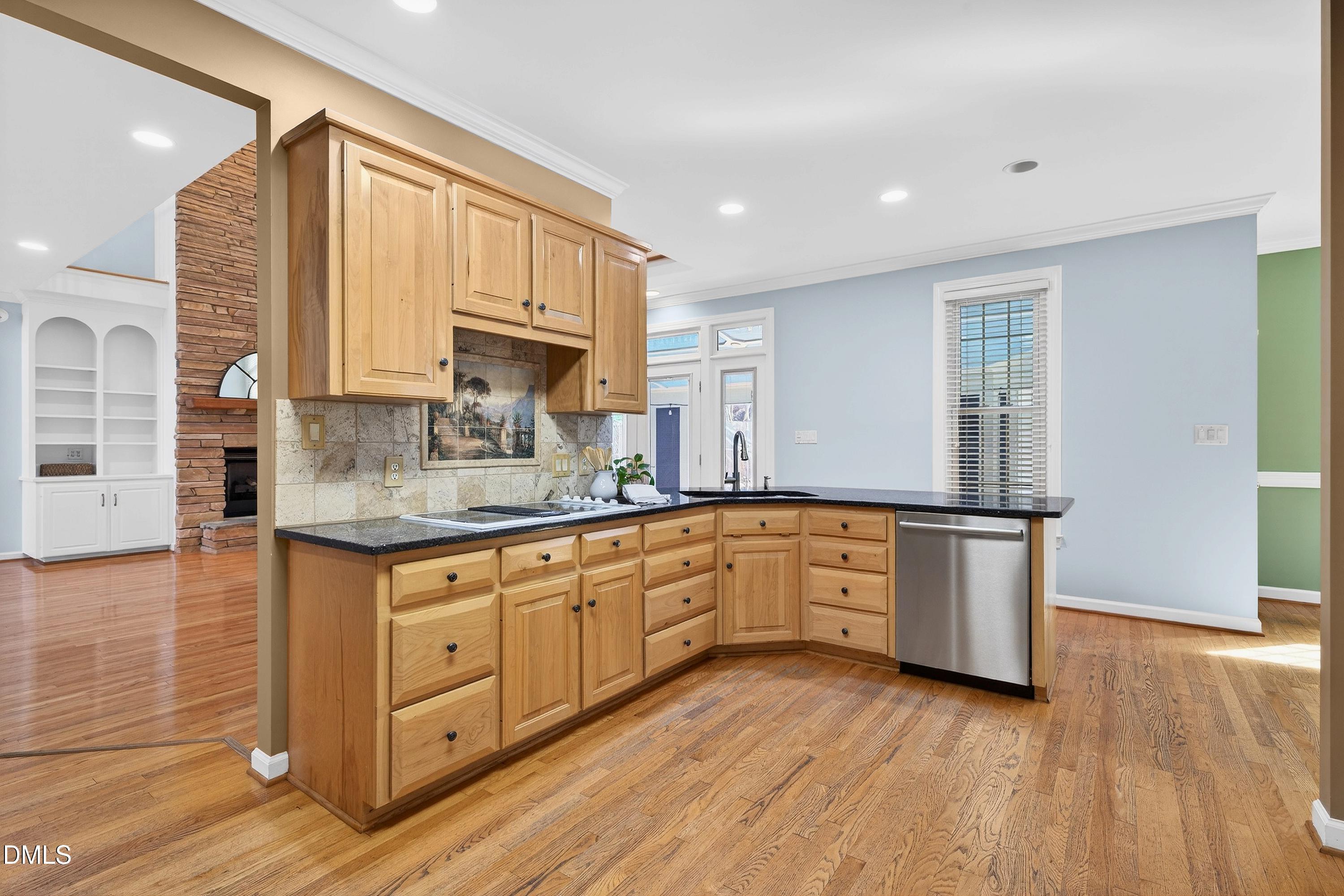 2217 Moss Point Lane Raleigh, NC 27606 - Photo 18 of 70 a kitchen with granite countertop white cabinets and white appliances