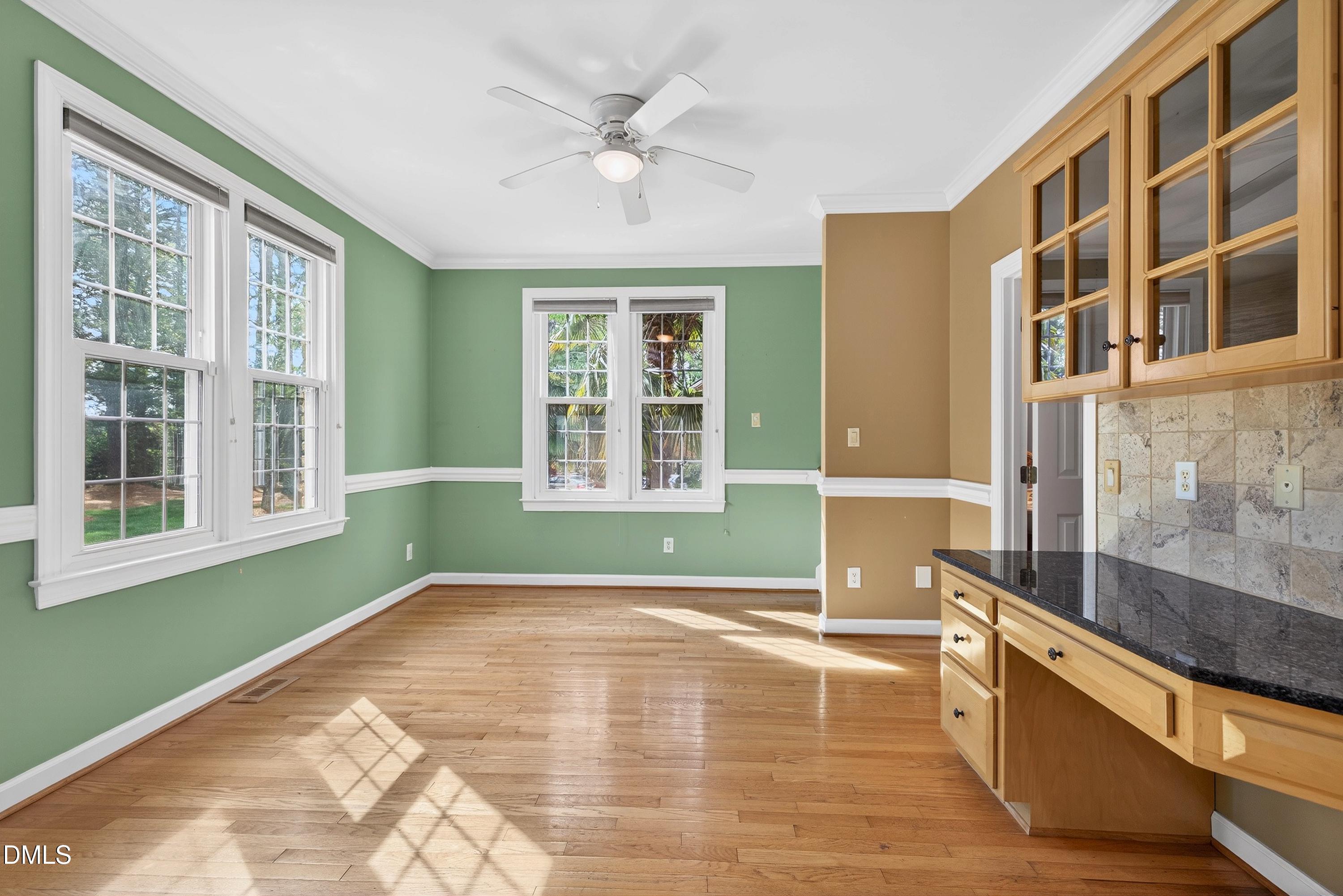2217 Moss Point Lane Raleigh, NC 27606 - Photo 23 of 70 a view of an empty room with wooden floor and a window
