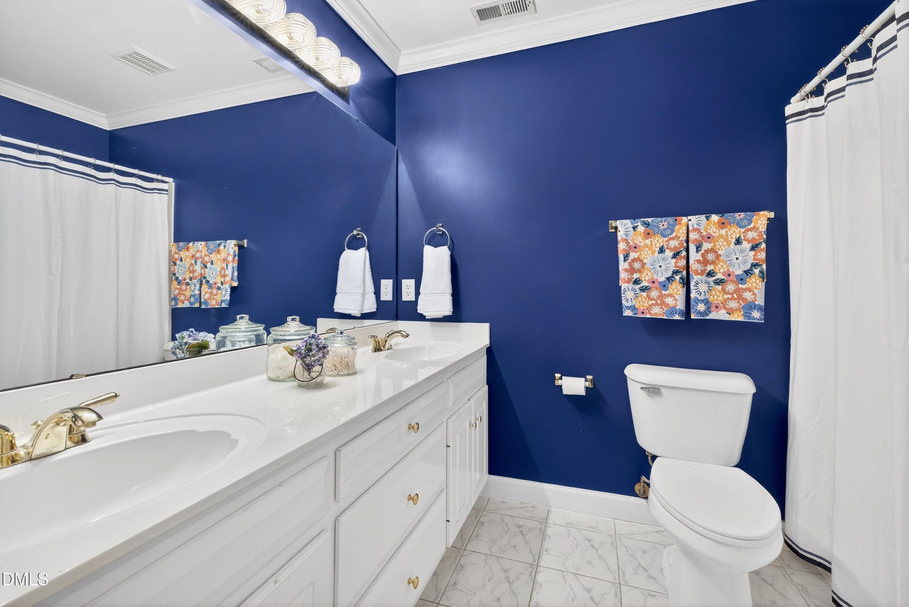 2217 Moss Point Lane Raleigh, NC 27606 - Photo 42 of 70 a bathroom with a toilet a sink and mirror