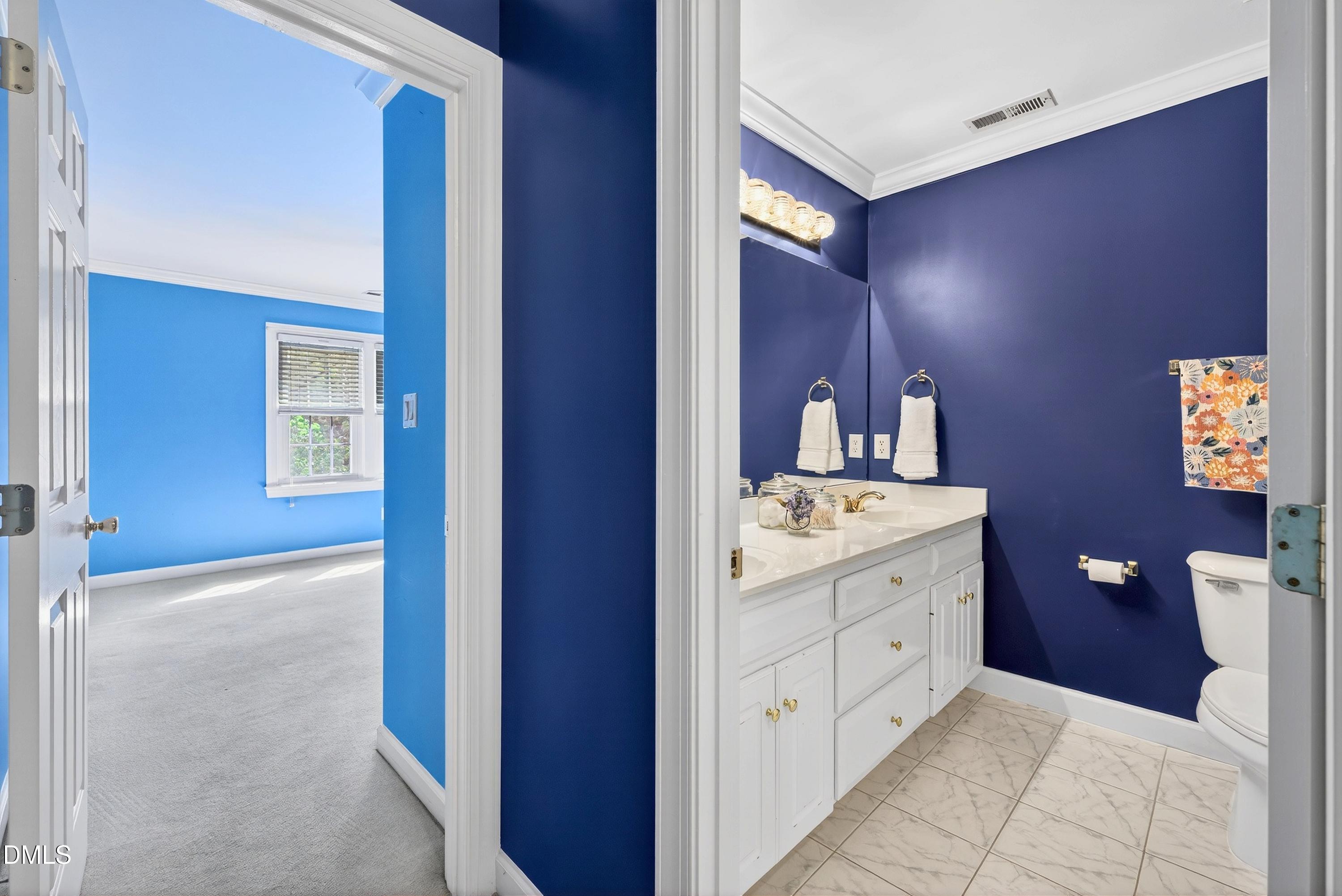 2217 Moss Point Lane Raleigh, NC 27606 - Photo 43 of 70 a bathroom with a double vanity sink and a mirror