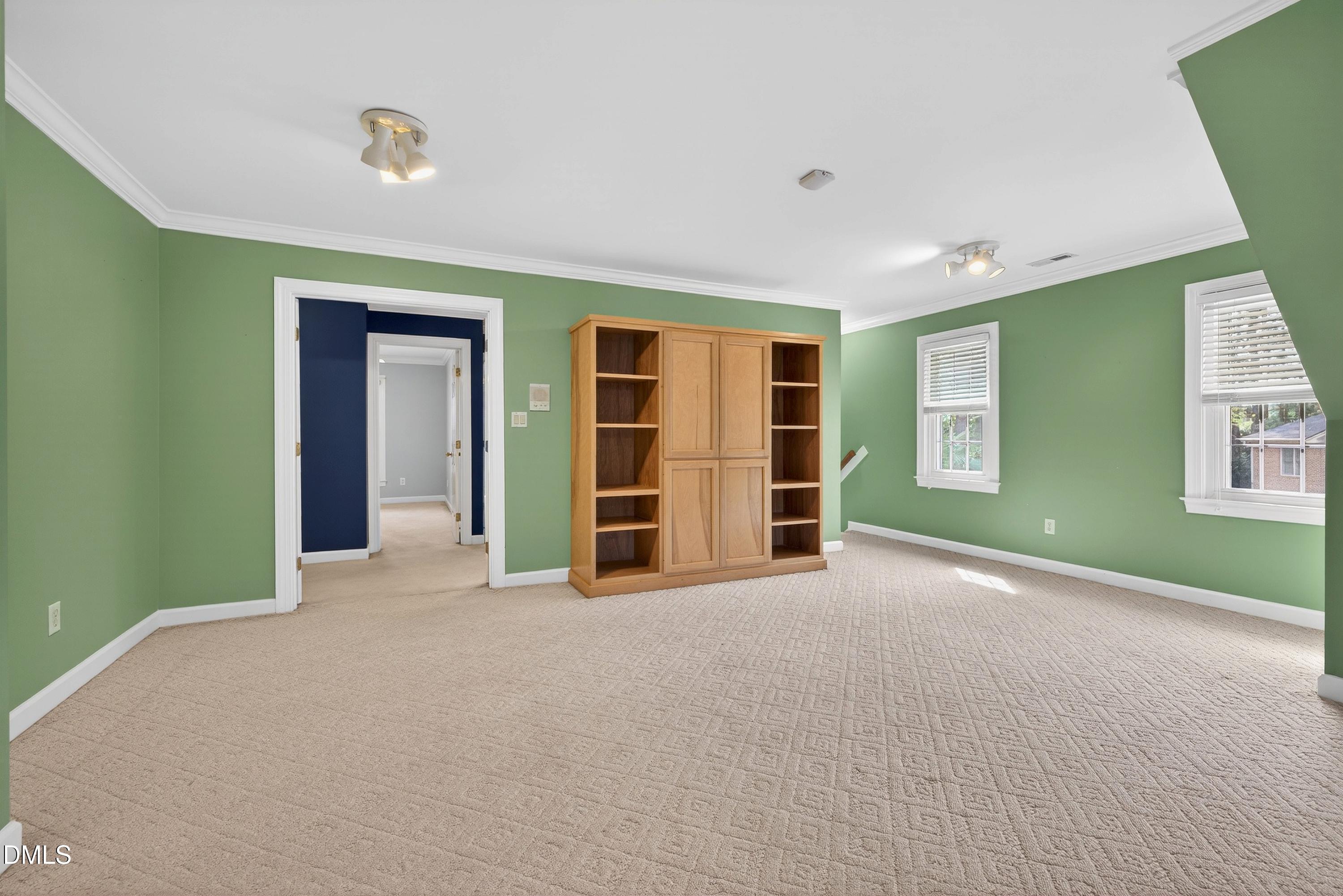 2217 Moss Point Lane Raleigh, NC 27606 - Photo 46 of 70 a view of an empty room with a window and a kitchen