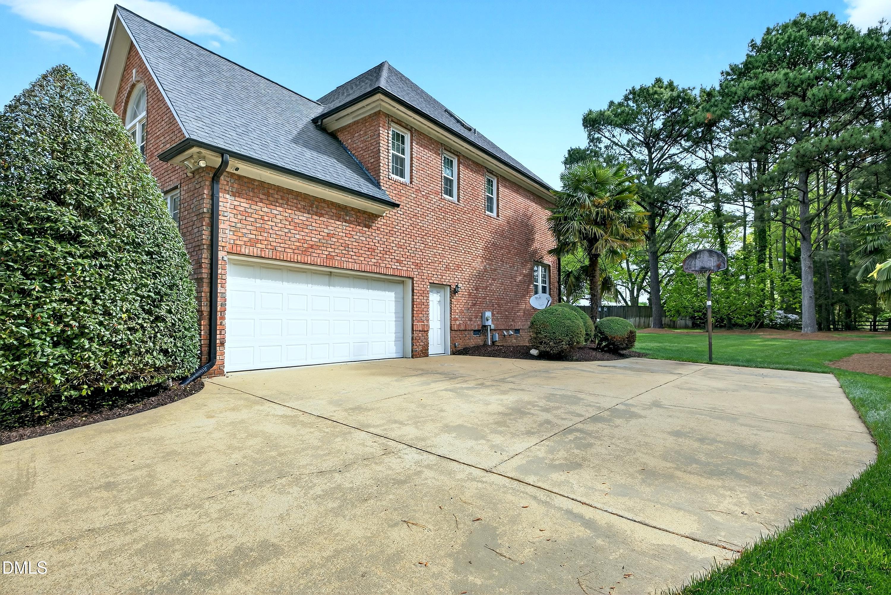 2217 Moss Point Lane Raleigh, NC 27606 - Photo 53 of 70 a front view of a house with a yard and garage
