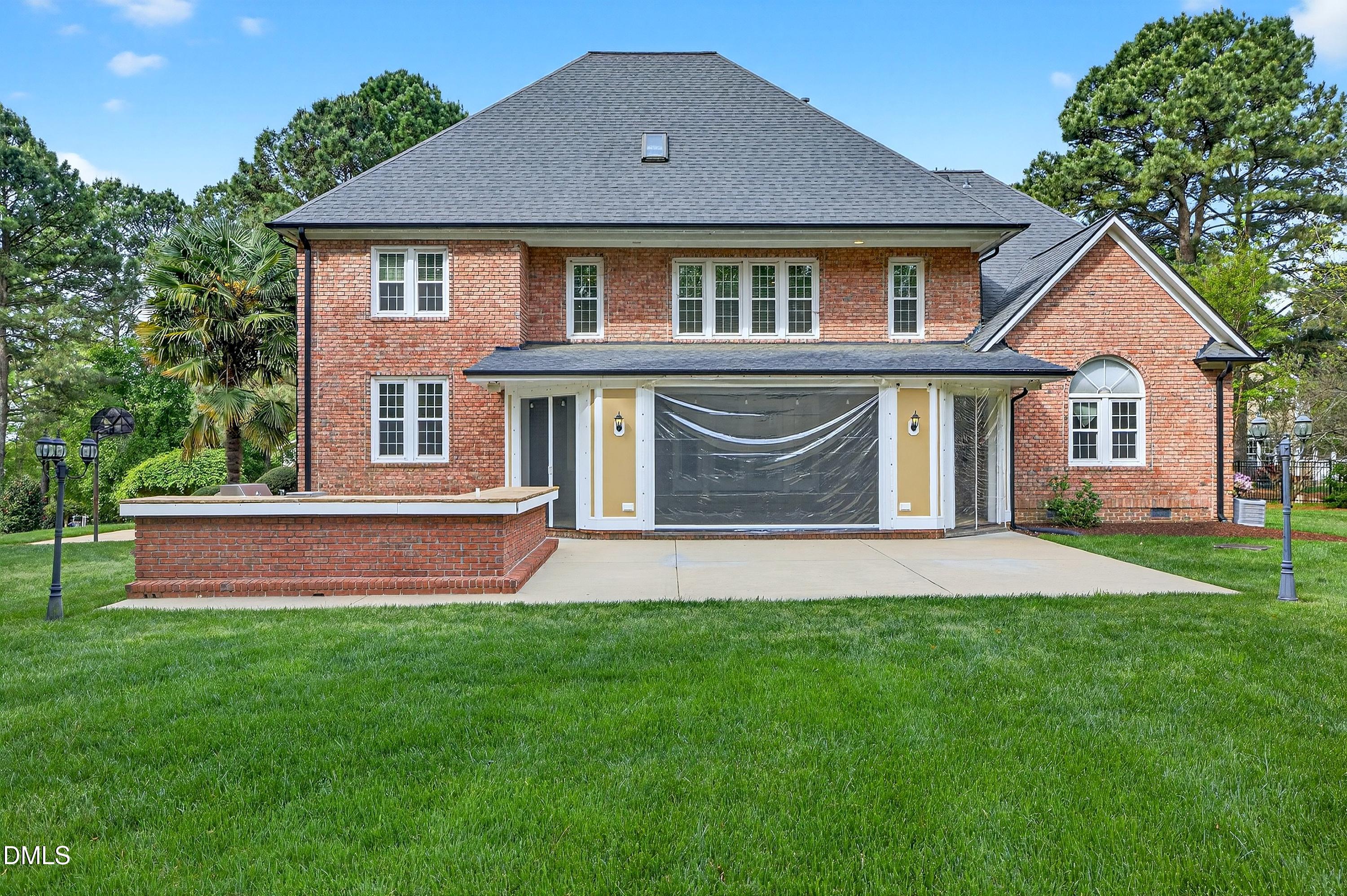 2217 Moss Point Lane Raleigh, NC 27606 - Photo 57 of 70 a front view of a house with a yard and garage