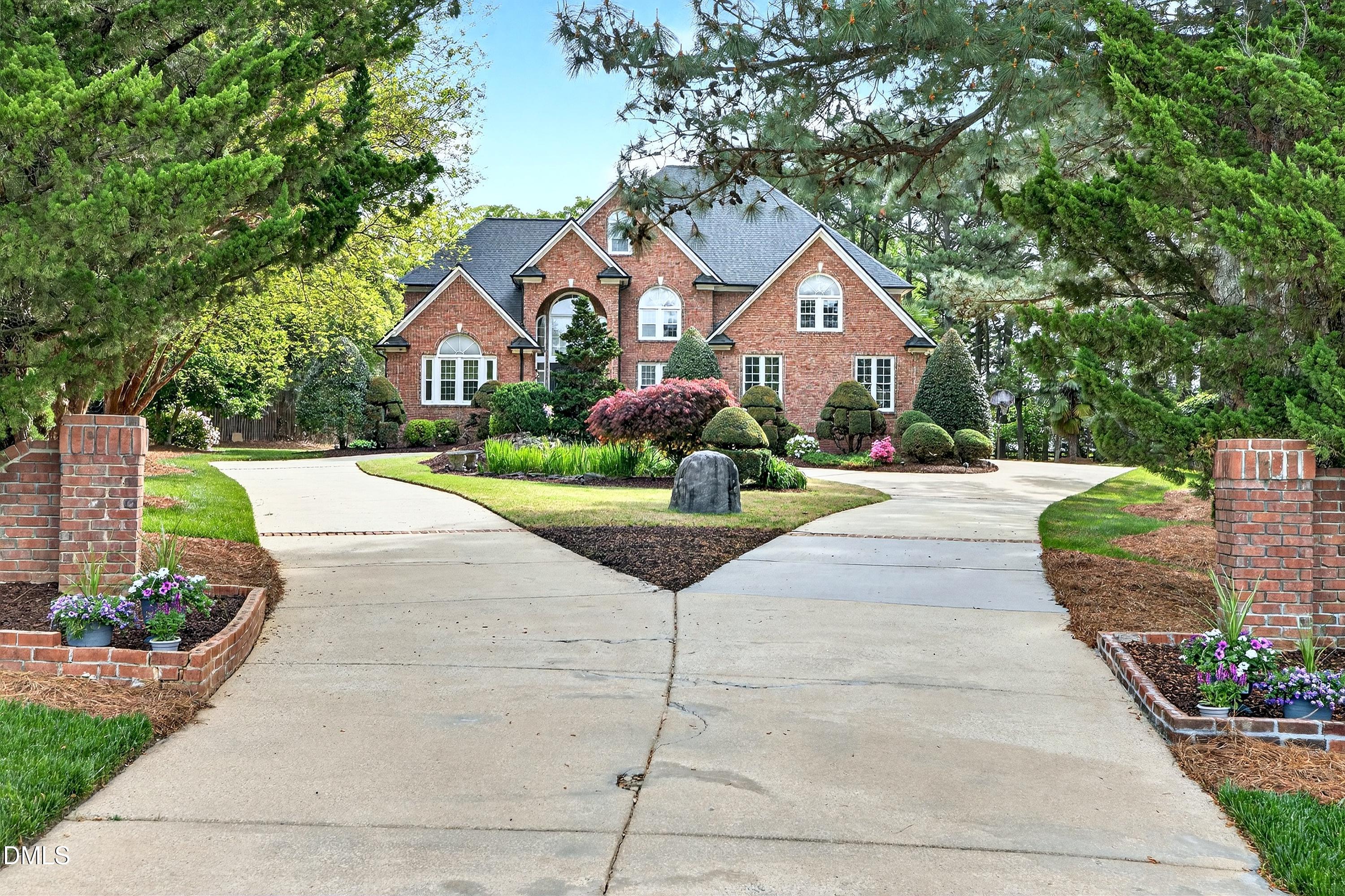 2217 Moss Point Lane Raleigh, NC 27606 - Photo 58 of 70 a front view of a house with a yard and garage