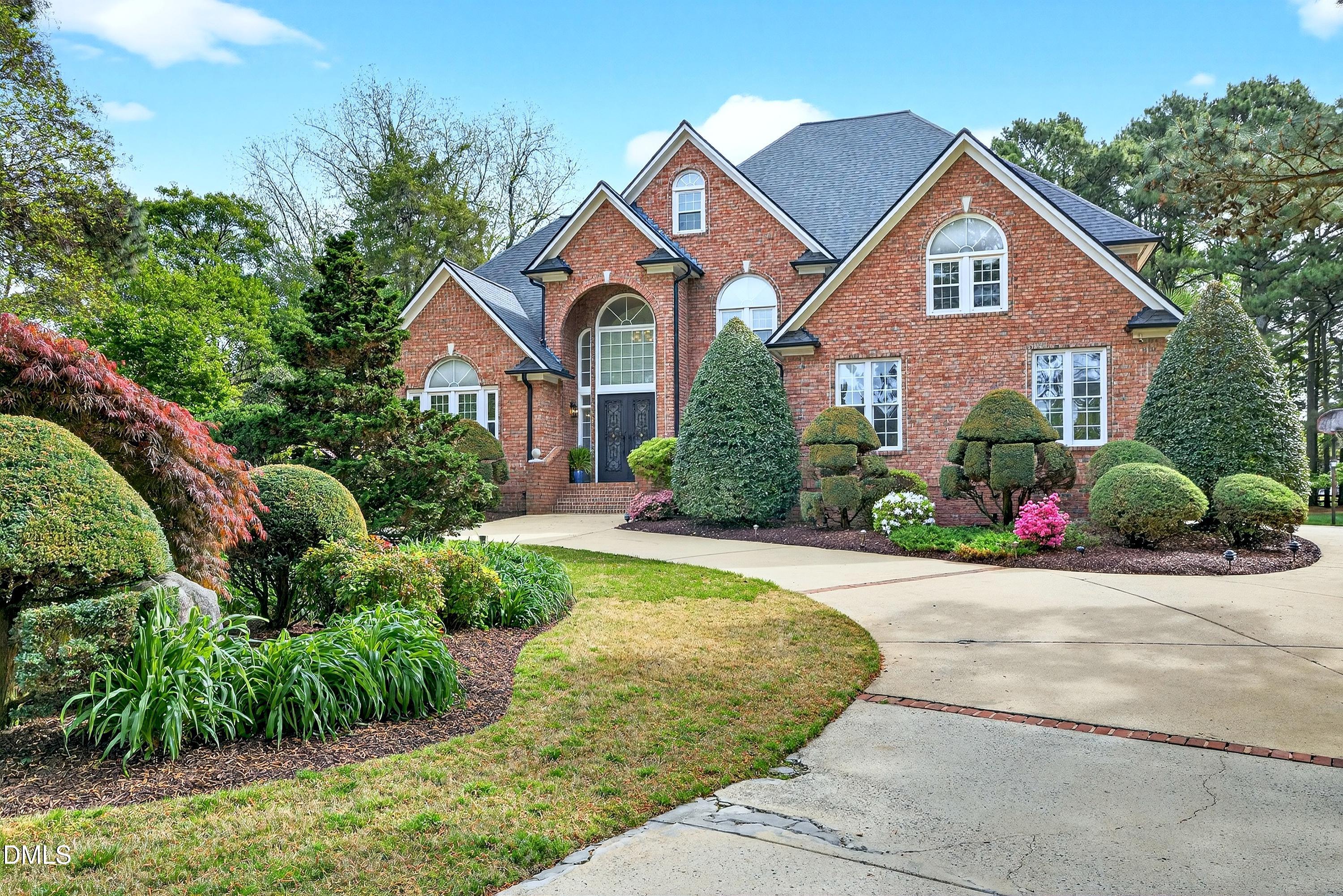 2217 Moss Point Lane Raleigh, NC 27606 - Photo 59 of 70 a front view of a house with a yard and garage