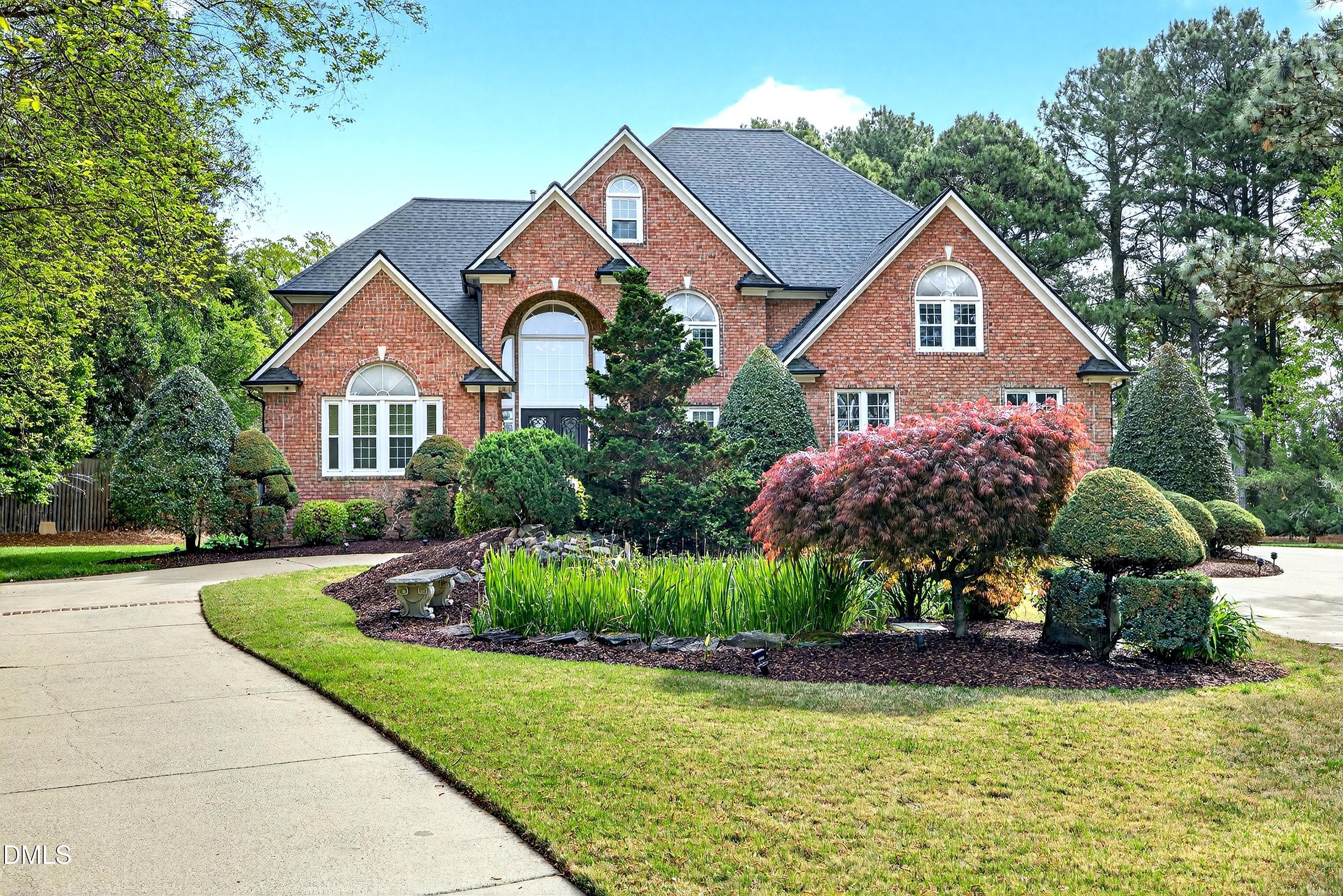 2217 Moss Point Lane Raleigh, NC 27606 - Photo 60 of 70 a front view of a house with a yard and garage