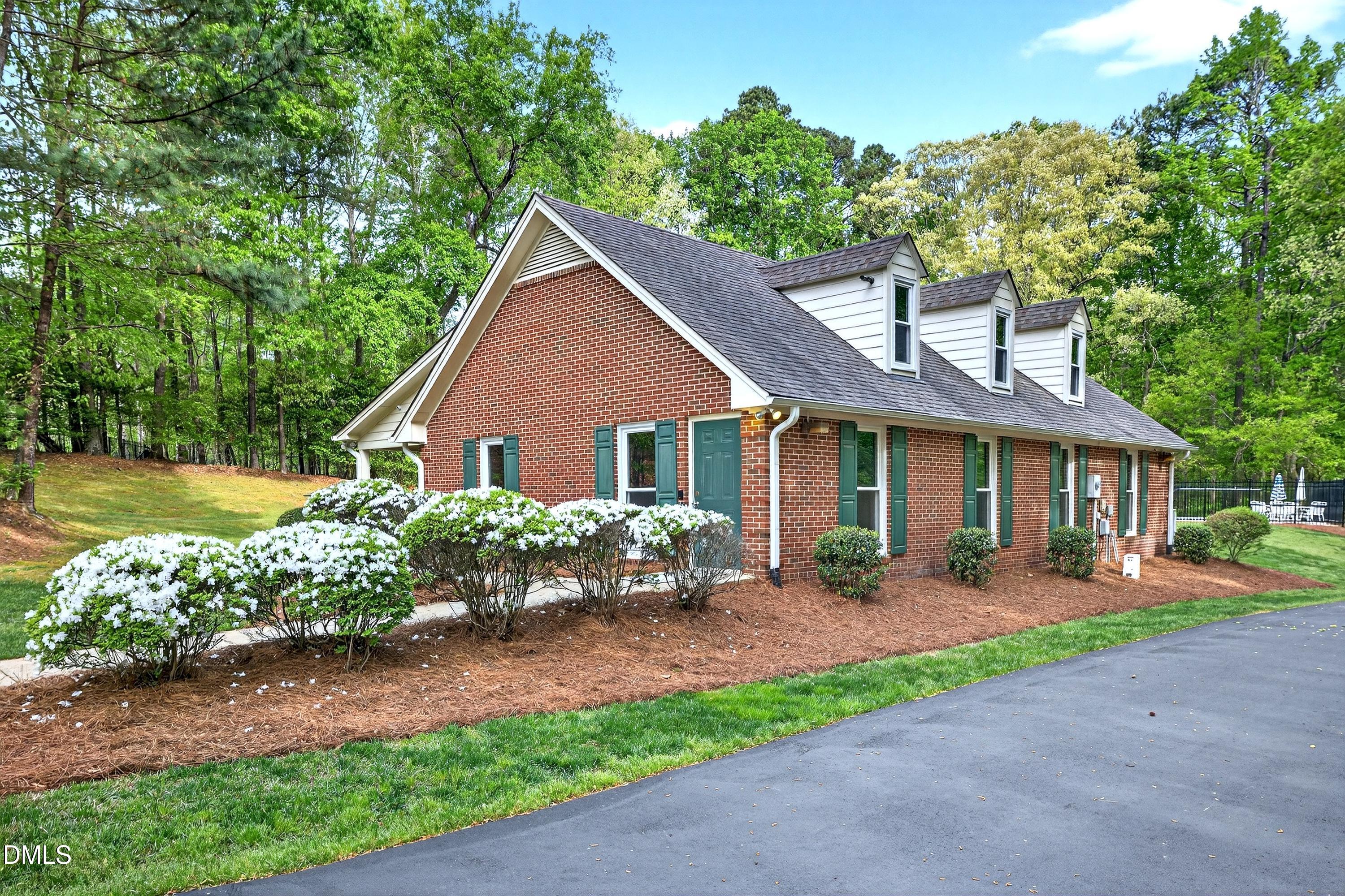 2217 Moss Point Lane Raleigh, NC 27606 - Photo 63 of 70 a front view of a house with a garden and outdoor seating