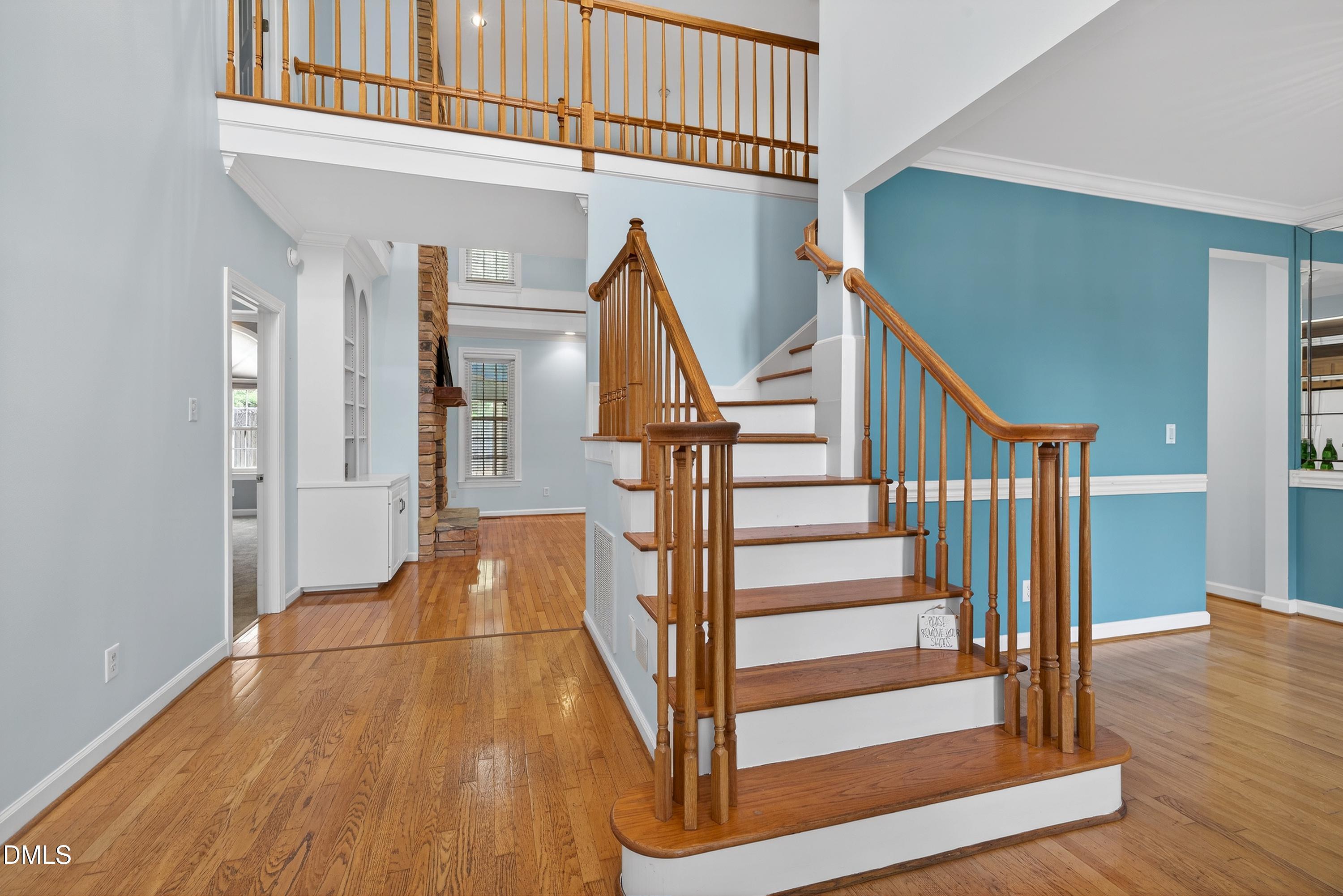 2217 Moss Point Lane Raleigh, NC 27606 - Photo 5 of 70 a view of entryway with wooden floor and stairs