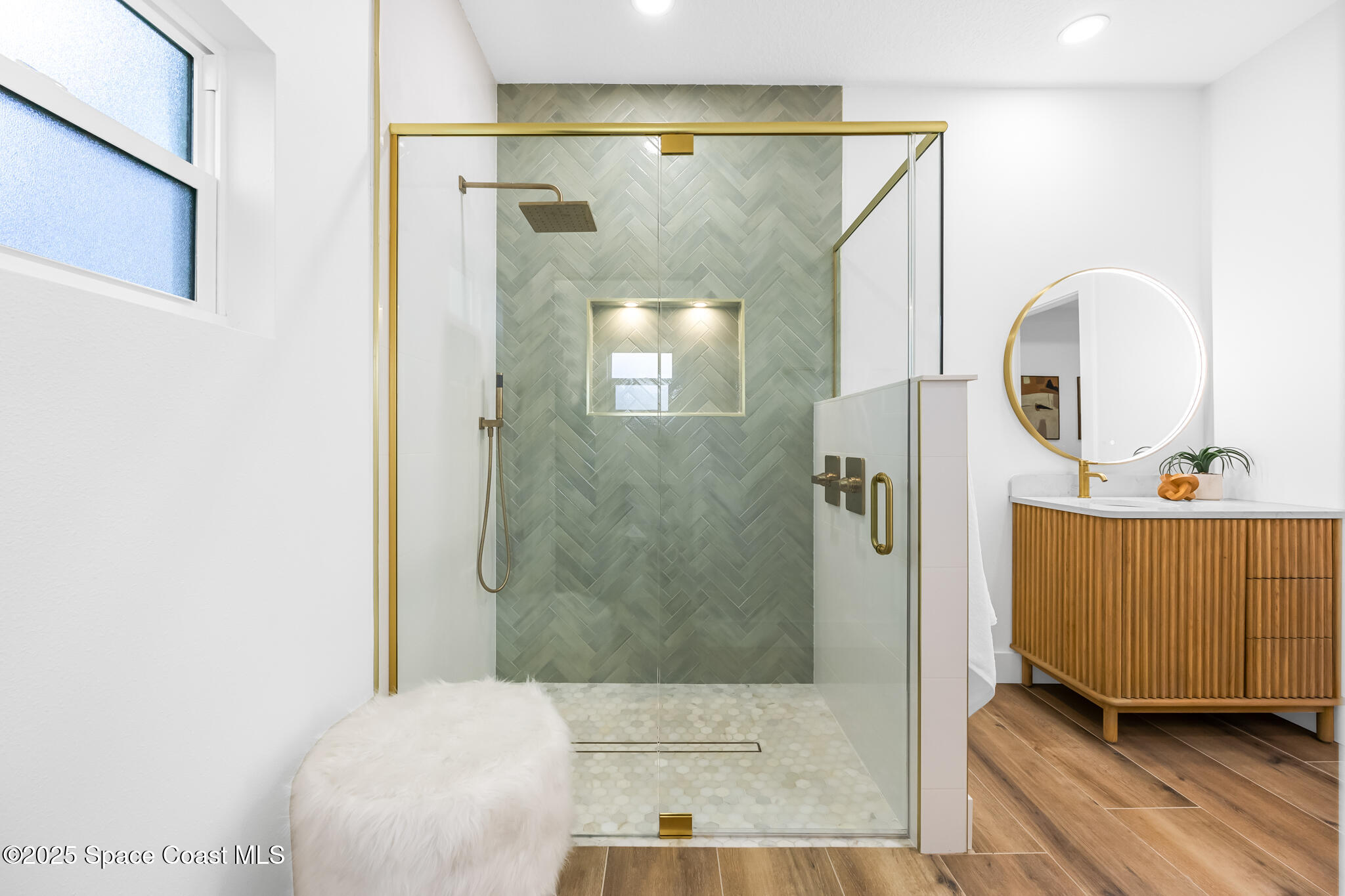 1313 Worth Court Northeast Palm Bay, FL 32905 - Photo 13 of 77 a bathroom with a sink a mirror and a shower