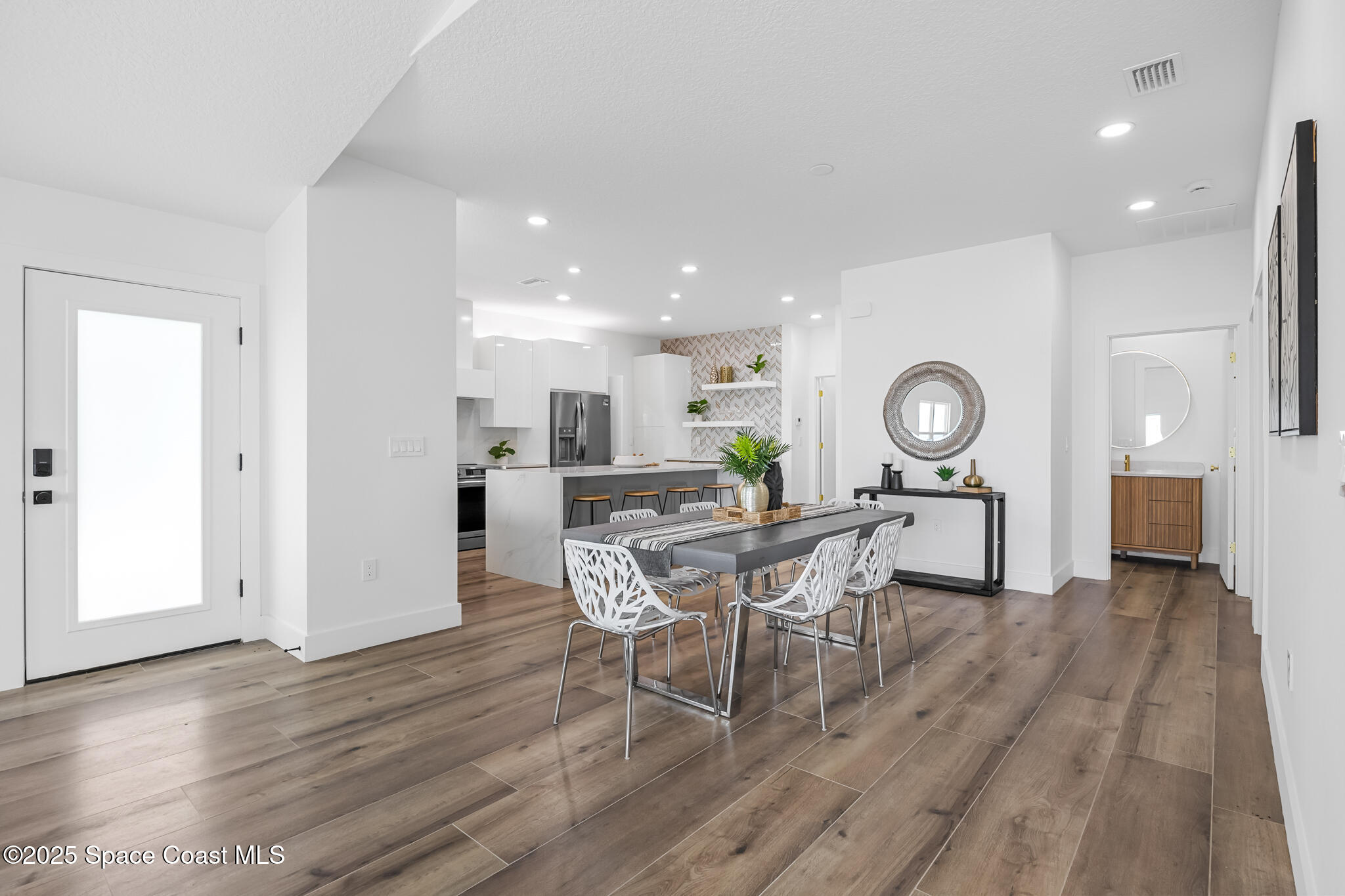 1313 Worth Court Northeast Palm Bay, FL 32905 - Photo 18 of 77 a view of a dining room with furniture and wooden floor