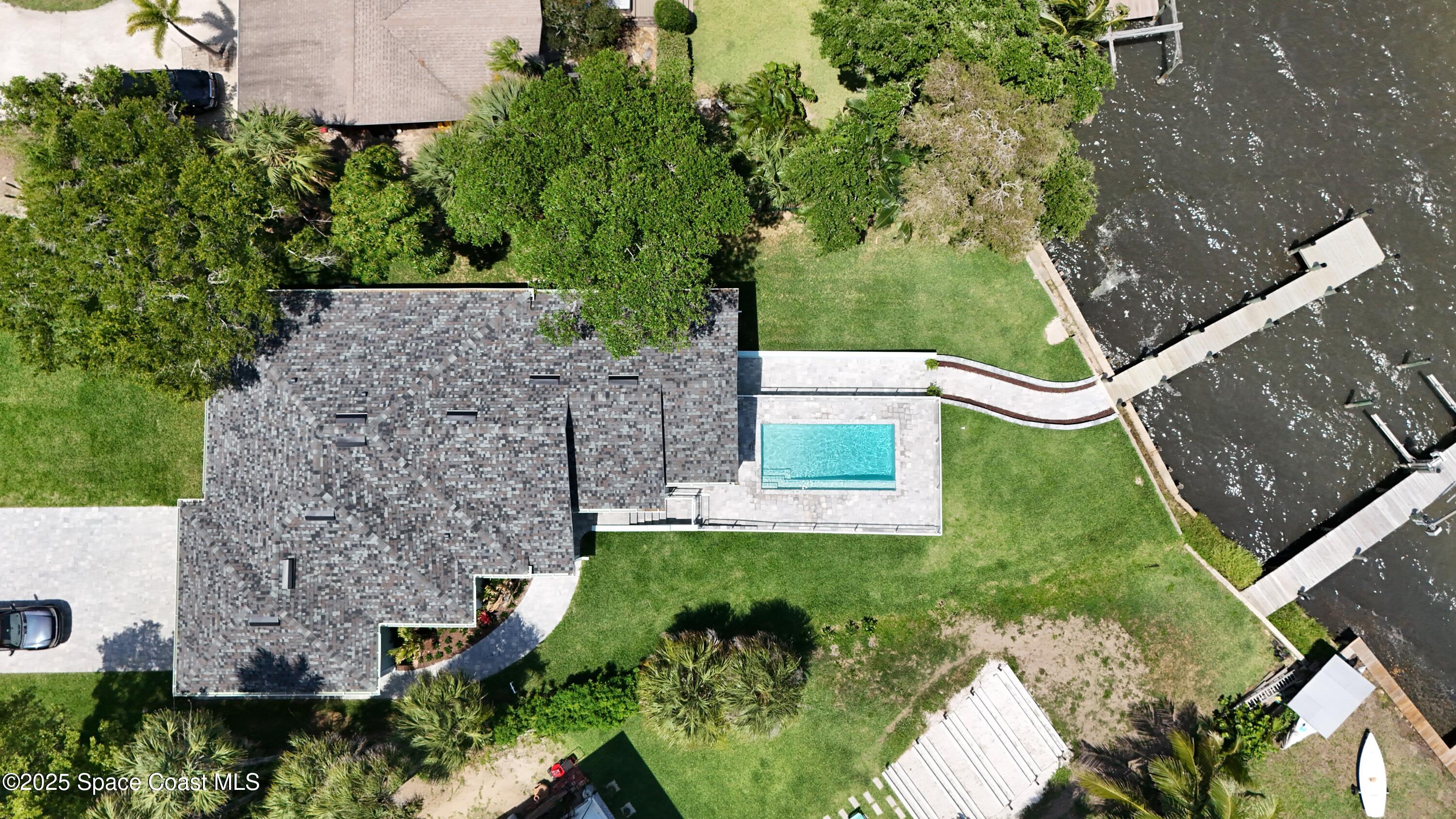 1313 Worth Court Northeast Palm Bay, FL 32905 - Photo 2 of 77 an aerial view of a house with a yard and outdoor seating