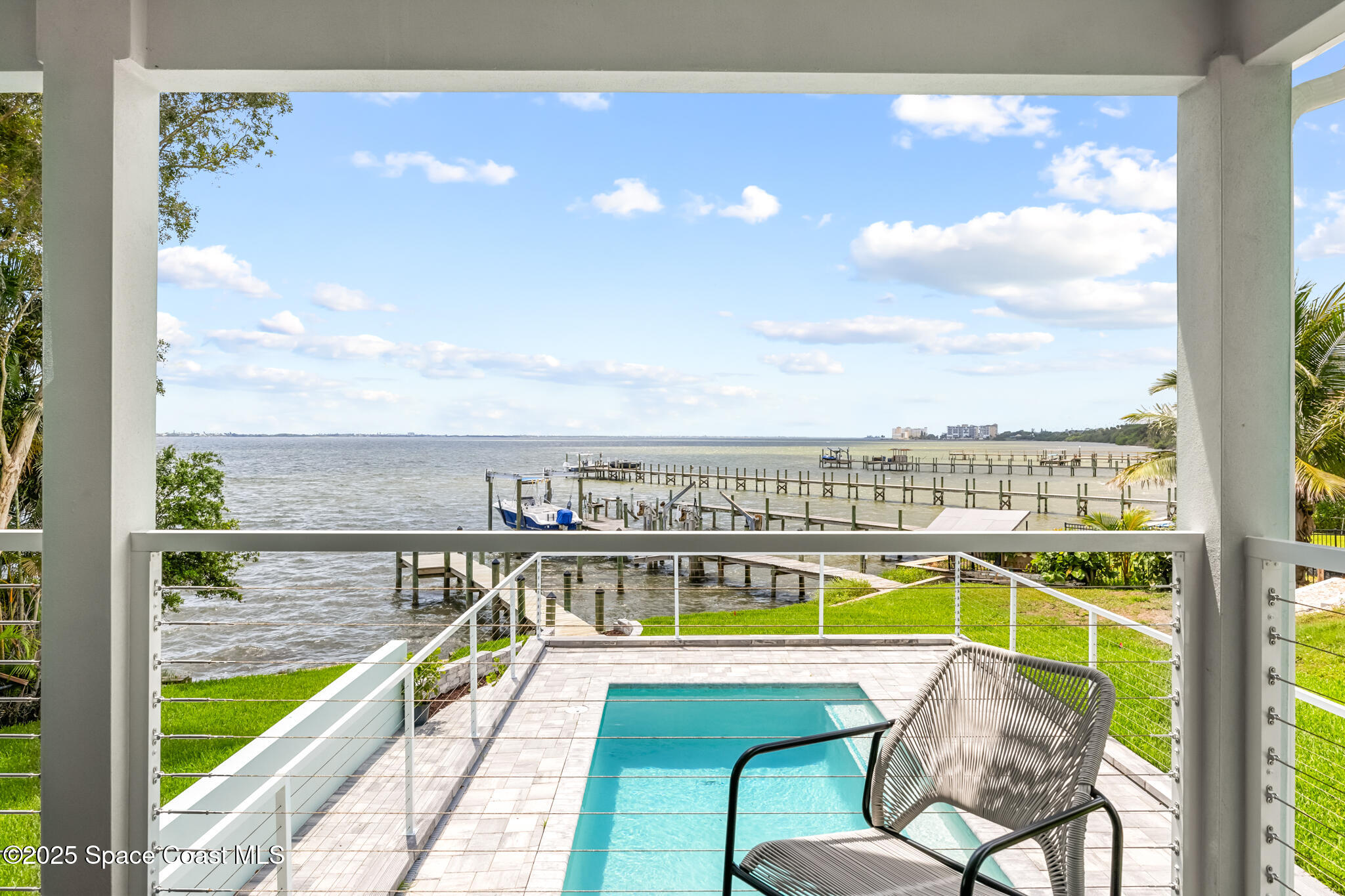 1313 Worth Court Northeast Palm Bay, FL 32905 - Photo 33 of 77 a view of a swimming pool with an ocean view