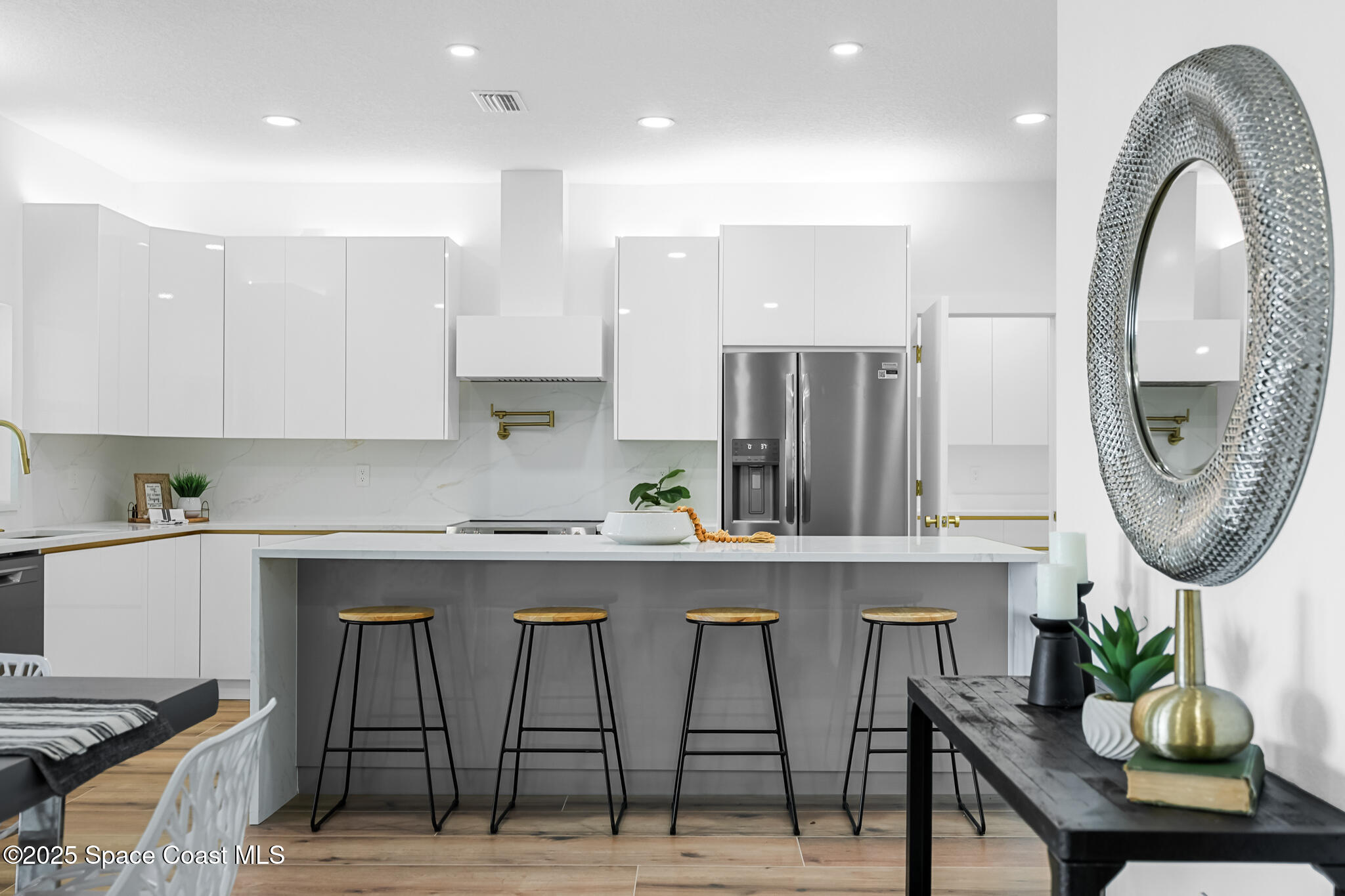 1313 Worth Court Northeast Palm Bay, FL 32905 - Photo 34 of 77 a kitchen with stainless steel appliances granite countertop a table and chairs in it