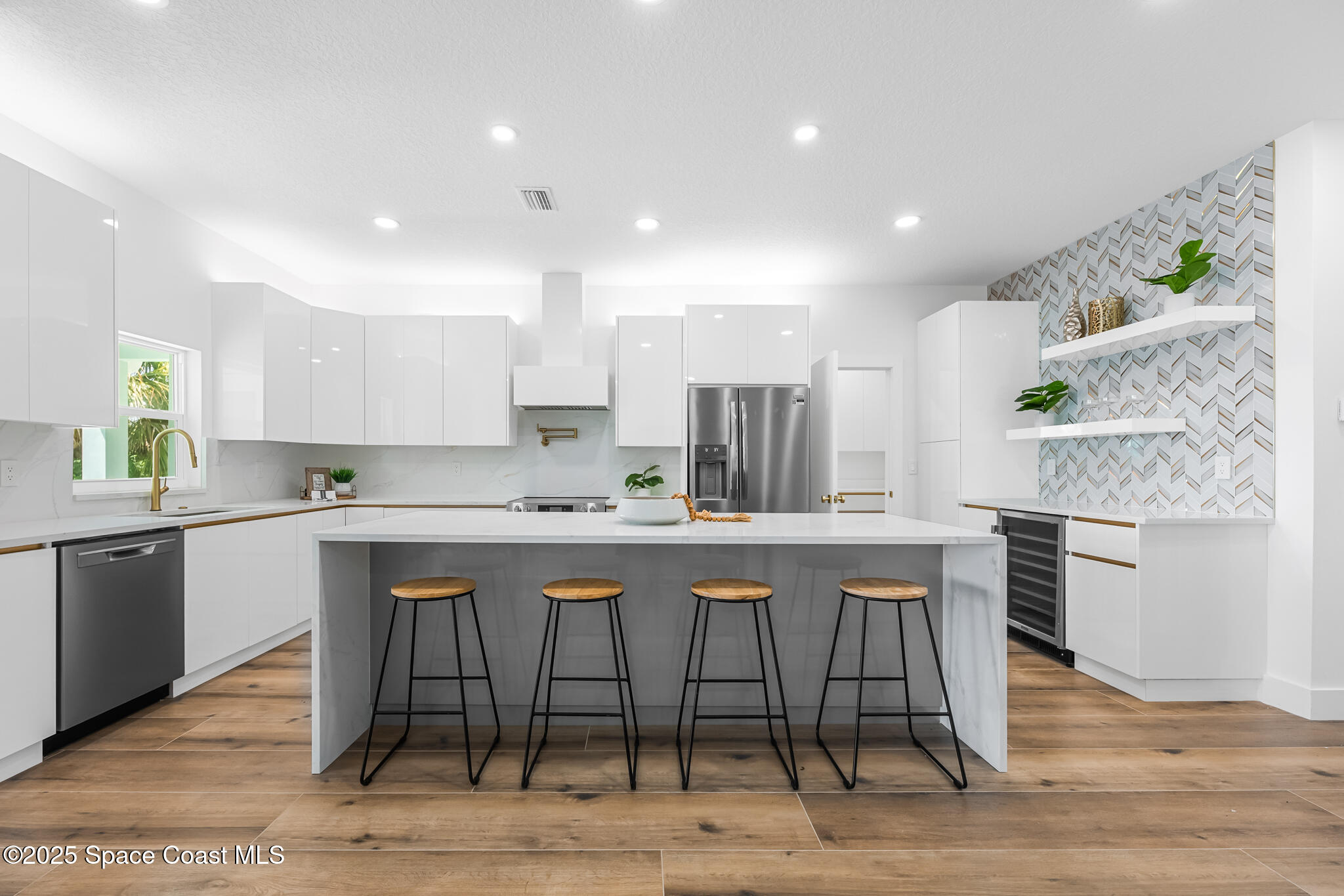 1313 Worth Court Northeast Palm Bay, FL 32905 - Photo 35 of 77 a kitchen with stainless steel appliances granite countertop a white table chairs and granite counter tops