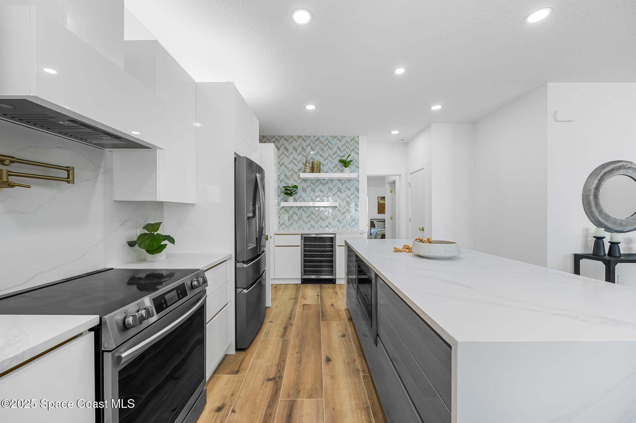 1313 Worth Court Northeast Palm Bay, FL 32905 - Photo 39 of 77 a kitchen with kitchen island granite countertop a sink stove and refrigerator
