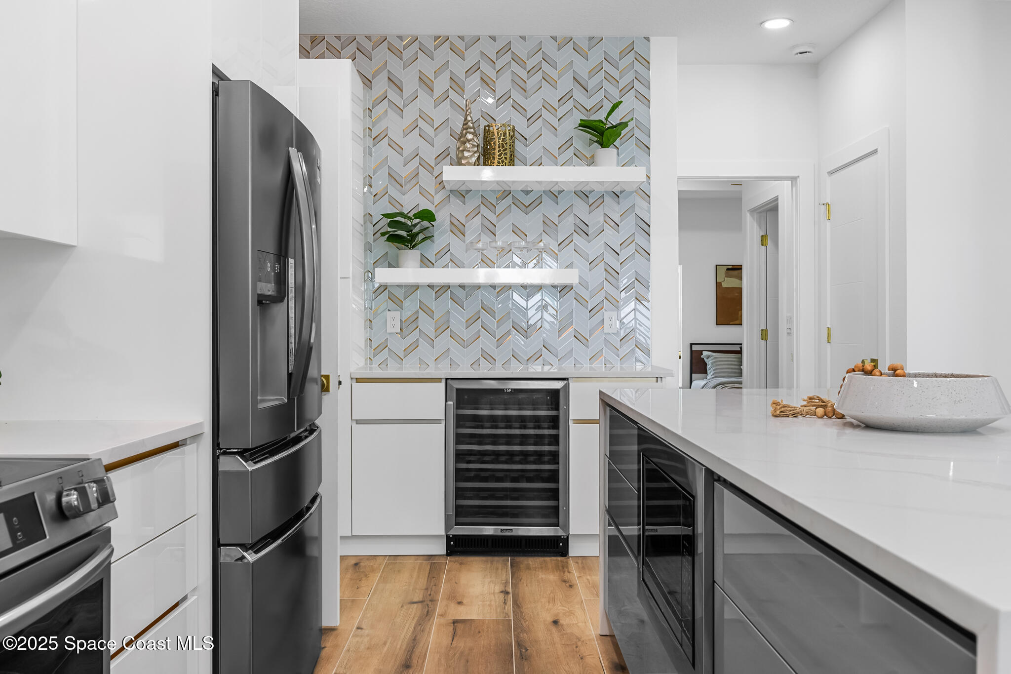 1313 Worth Court Northeast Palm Bay, FL 32905 - Photo 40 of 77 a kitchen with a refrigerator and a sink