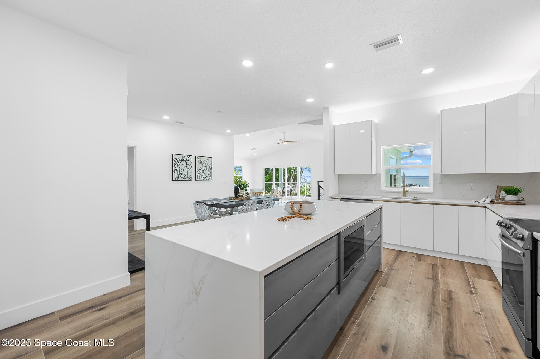 1313 Worth Court Northeast Palm Bay, FL 32905 - Photo 42 of 77 a kitchen with a sink stove and cabinets