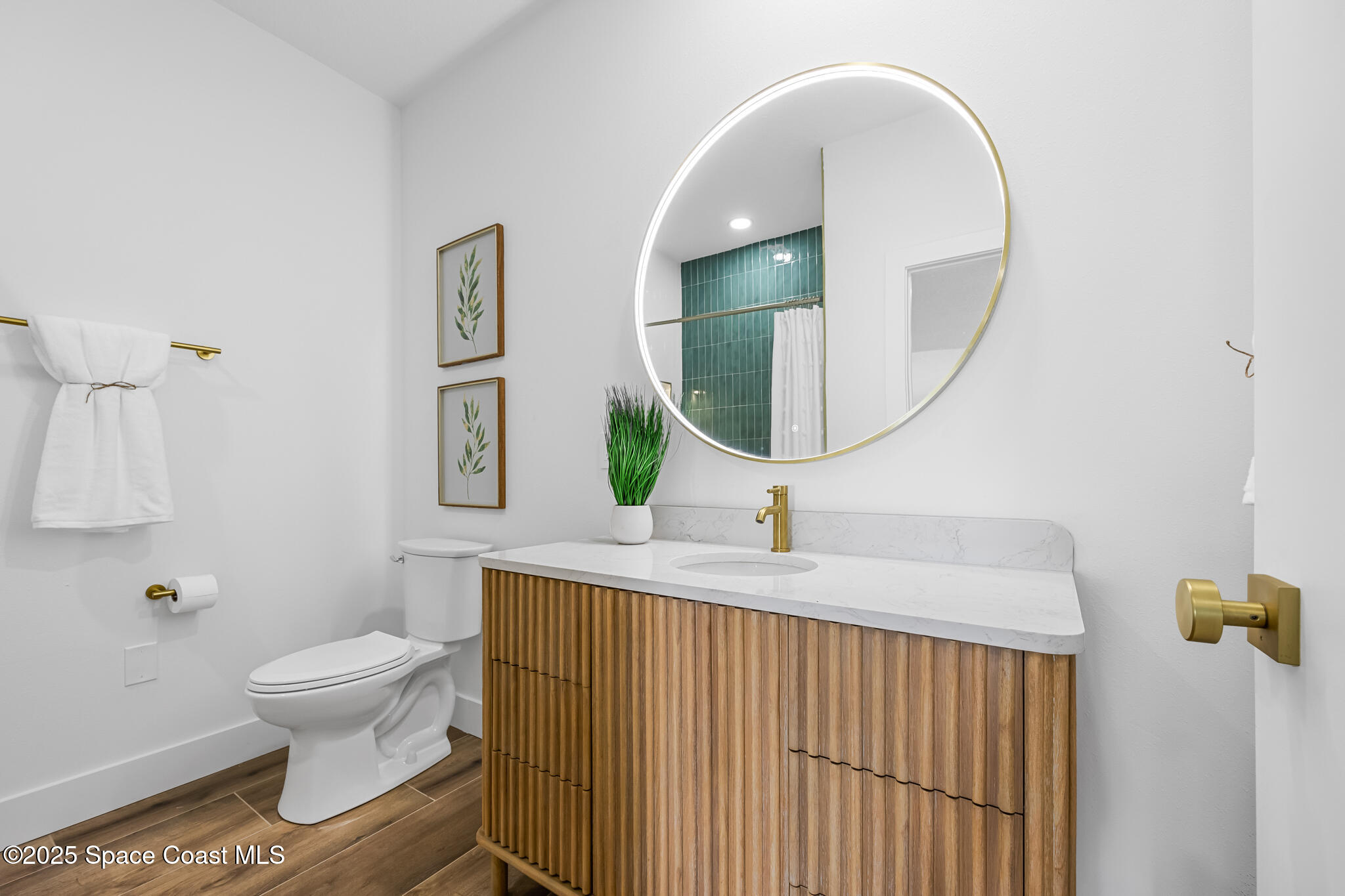1313 Worth Court Northeast Palm Bay, FL 32905 - Photo 47 of 77 a bathroom with a toilet a sink and a mirror