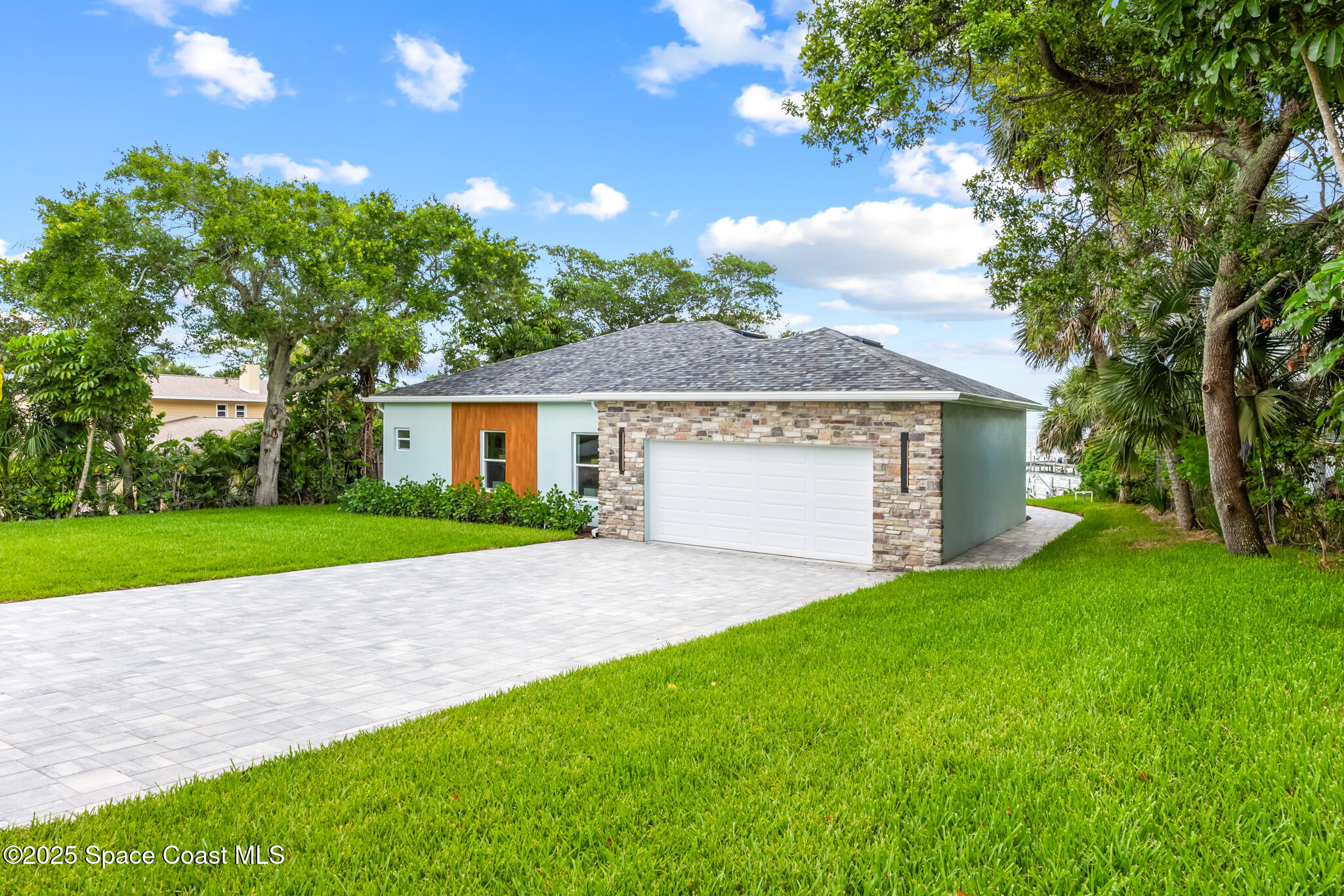 1313 Worth Court Northeast Palm Bay, FL 32905 - Photo 6 of 77 a view of a house with a yard and large tree