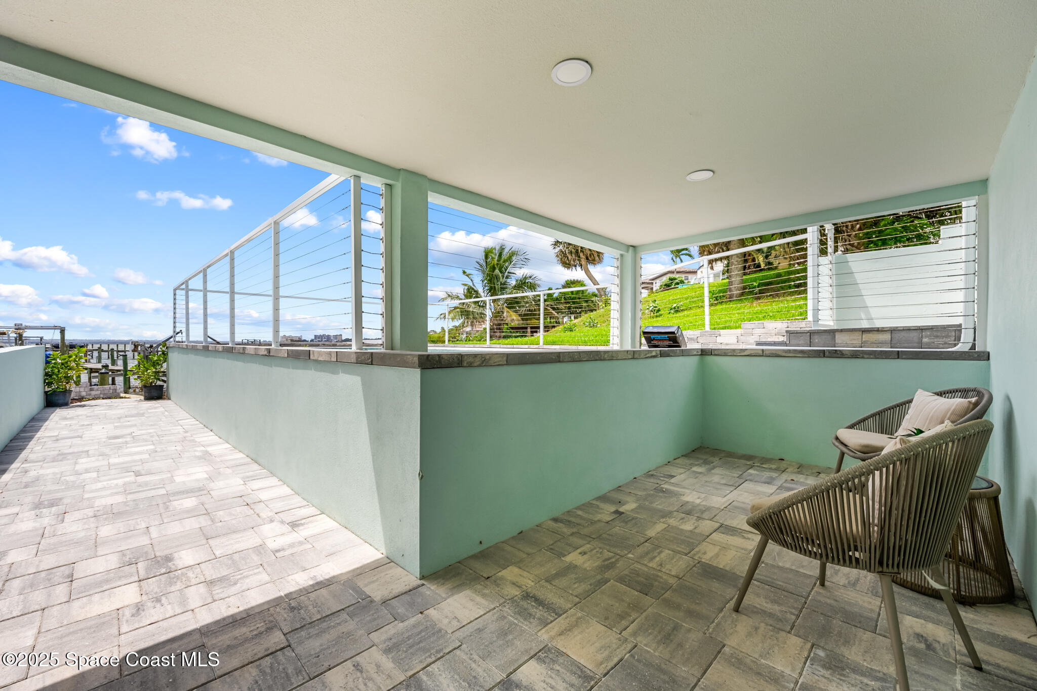 1313 Worth Court Northeast Palm Bay, FL 32905 - Photo 72 of 77 a kitchen with stainless steel appliances granite countertop a stove top oven cabinets a dining table and chairs