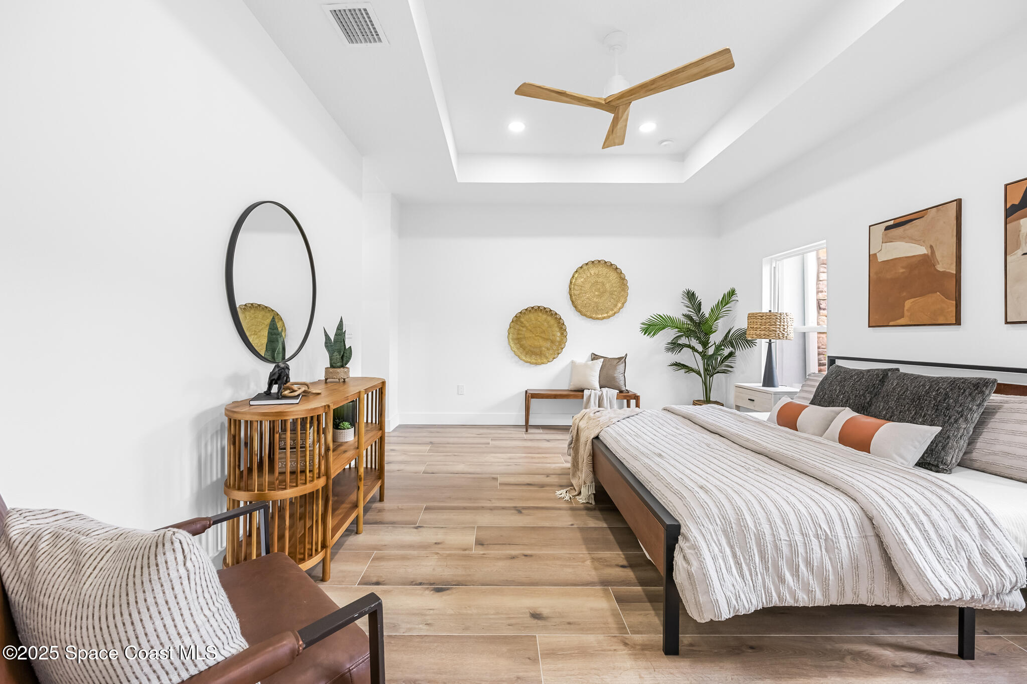 1313 Worth Court Northeast Palm Bay, FL 32905 - Photo 10 of 77 a bedroom with a bed and a chandelier