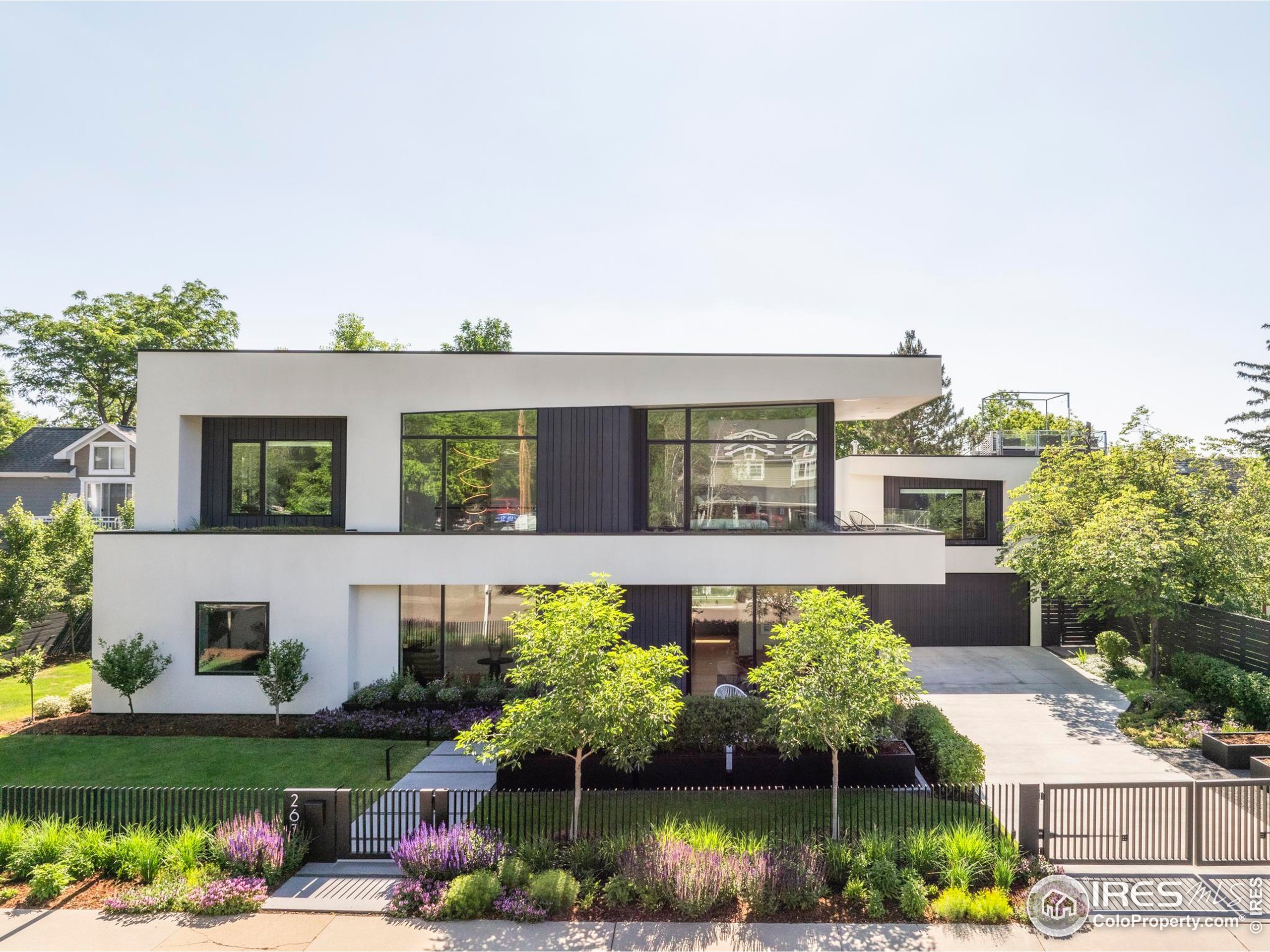 front view of house with a yard and potted plants