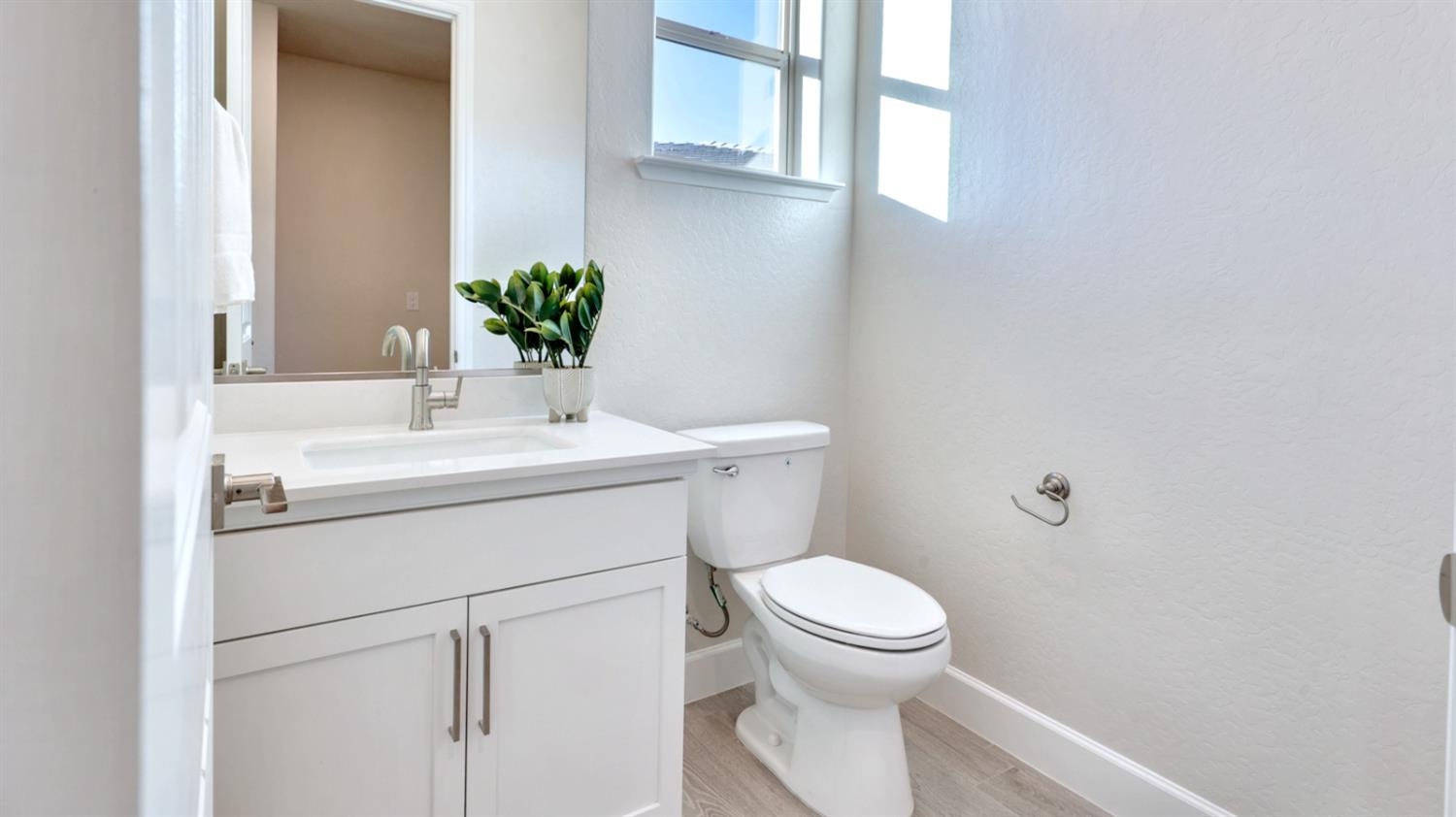 951 Talus Way South Madera, CA 93636 - Photo 16 of 36 a bathroom with a sink toilet and window