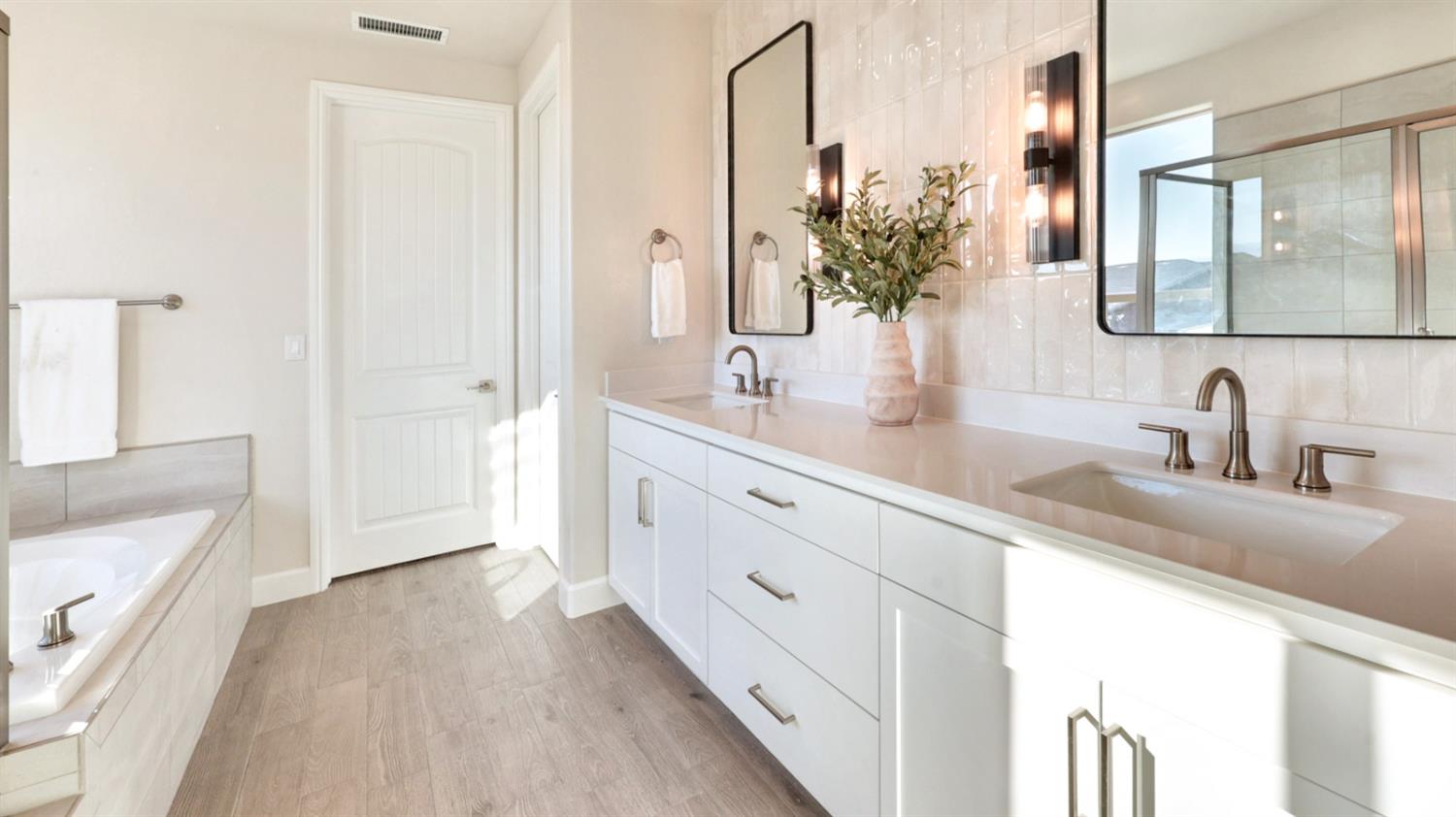 951 Talus Way South Madera, CA 93636 - Photo 19 of 36 a bathroom with a double vanity sink and mirror