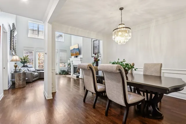 a view of a dining room with furniture wooden floor and a chandelier