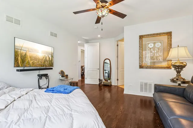 a bedroom with furniture and a flat screen tv
