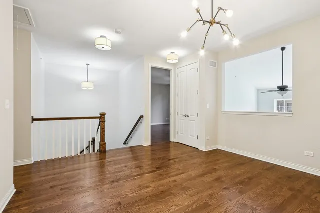 a view of a room with wooden floor and window