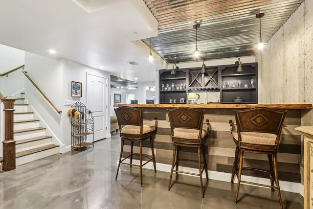 a dining area with furniture and a kitchen view