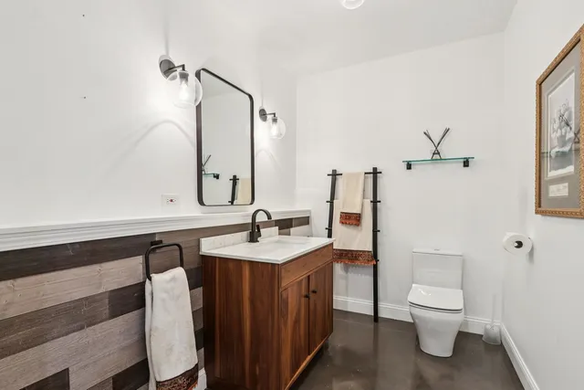 a bathroom with a toilet a sink and mirror