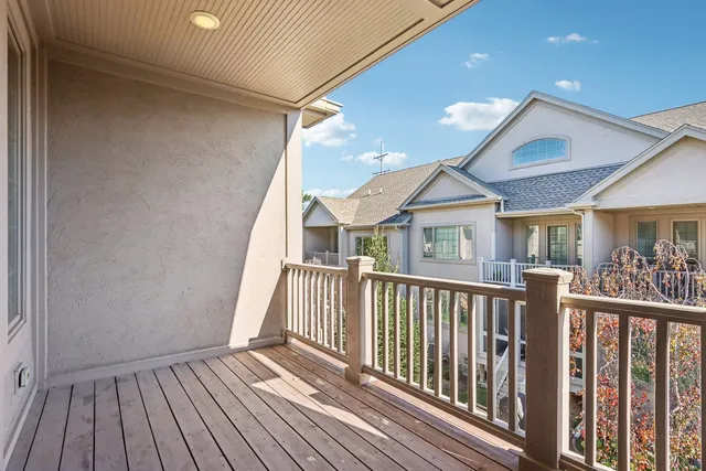 a view of a house with wooden deck