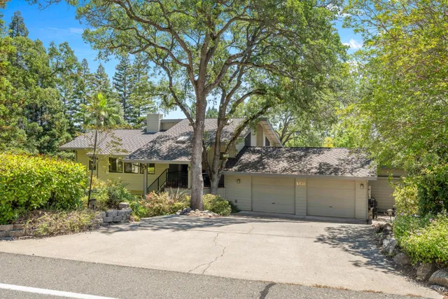 a front view of a house with a yard and a garage